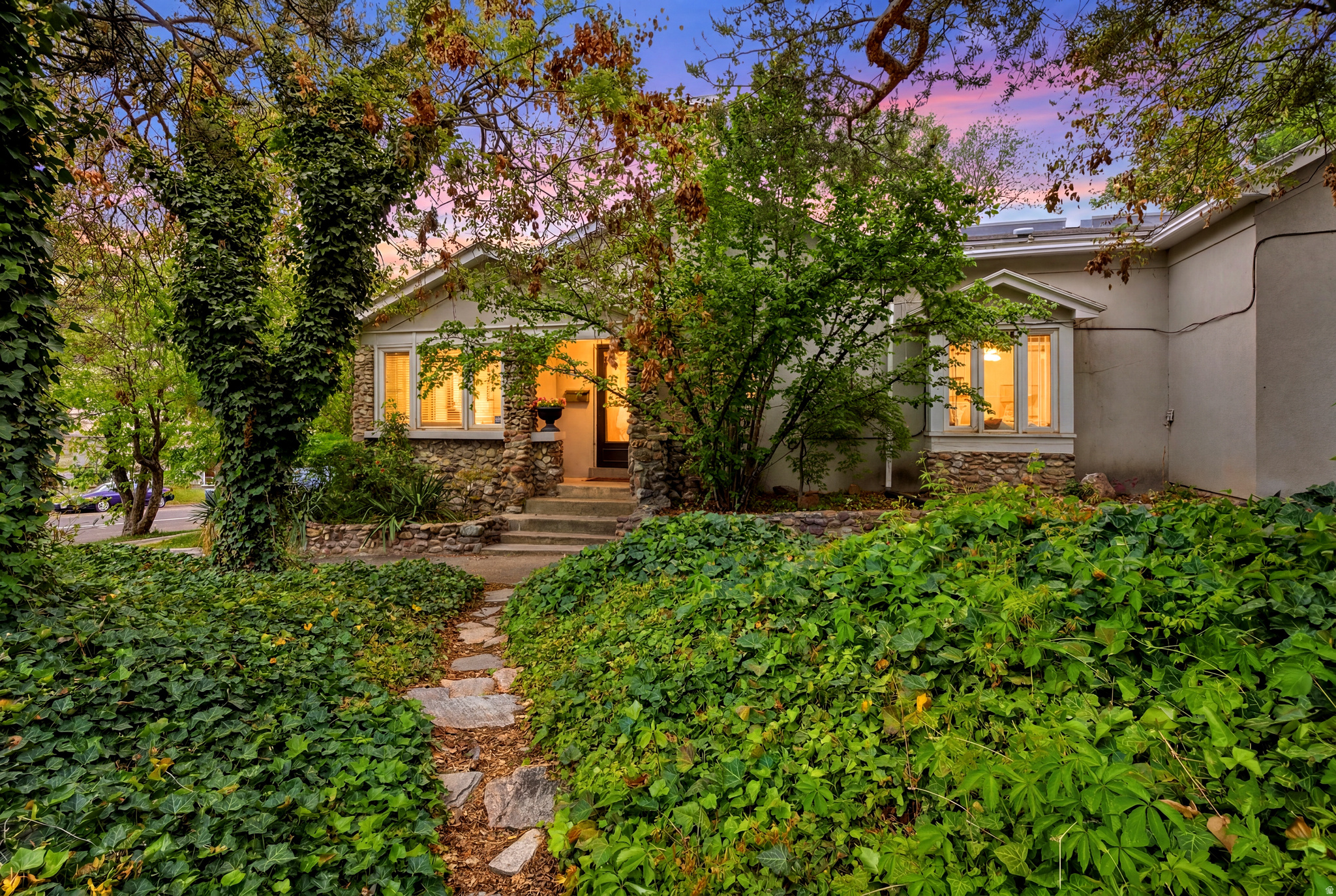 Built in 1891, this home has personality and character. From the locally sourced rock facade that carries inside with the stone gas fireplace, to the arched doorways and built in bookcases, there is a sense of charm that is unique to this house. The sunroom is a wonderful addition that brings in light and nature, along with the bay window in the dining room and the skylights in the kitchen. If you enjoy entertaining, this kitchen-dining- outdoor deck space is perfect for evening get-togethers and bbqs. The yard space is terraced and level, and the hot tub is included. Inside, there are three bedrooms with well designed layouts. Two of the three bedrooms capture loft space that creates multiple options for use. One of the bedrooms was once used as an ADU for students and short-term rentals allowing the property owner to earn extra income. The laundry-mud room is used for storage and has untapped potential. The unfinished basement houses the mechanicals. Water heater was updated in 2025 and the furnace was updated in 2020 & was recently serviced. There is even space for more storage or a possible man-cave or speak easy. Truly, this is one property you need to see in person. Now with a NEW price $150,000 below appraised value, too!!!