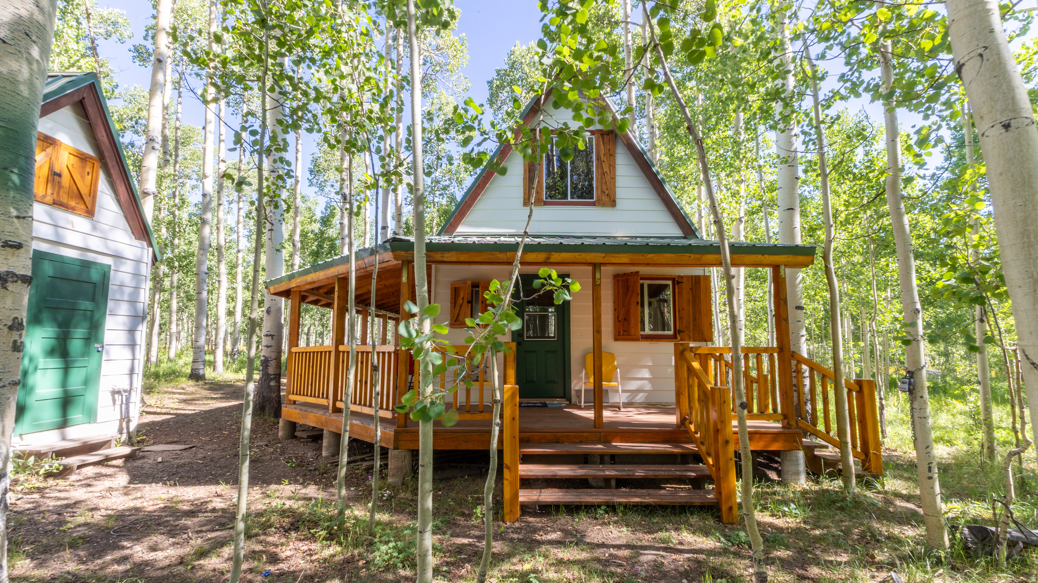 Charming mountain cabin nestled in the aspens! This cozy retreat offers rustic charm, privacy, and a peaceful wooded setting. Enjoy the inviting wraparound porch, warm wood finishes, loft-style sleeping area, vaulted living space, fireplace, functional kitchen, dining area, and bathroom. A detached outbuilding provides added storage or utility space. Surrounded by mature aspen trees, this property is ideal as a seasonal getaway, vacation cabin, hunting retreat, or quiet escape to enjoy the mountains and outdoors. A rare opportunity to own a secluded cabin in a beautiful natural setting.