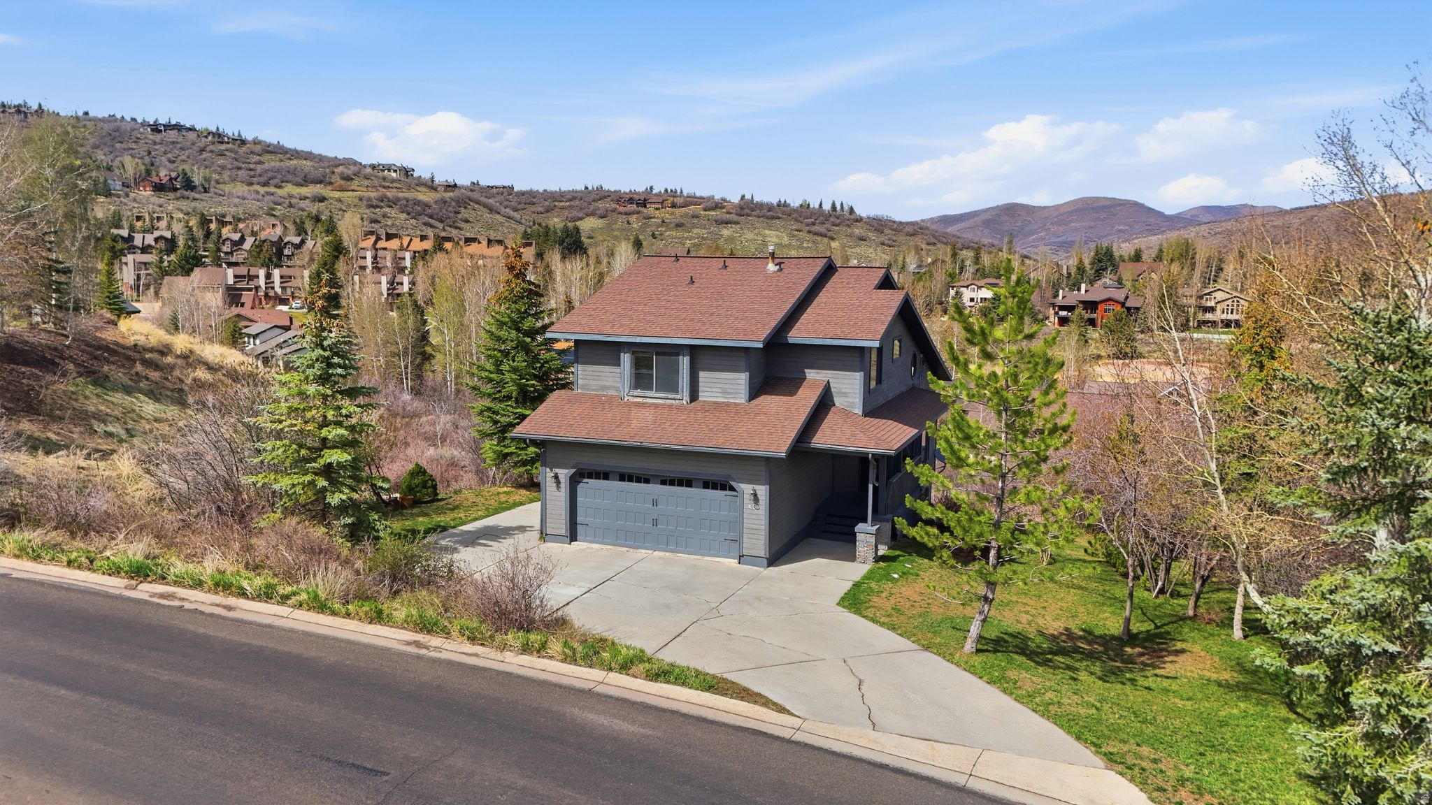 Perched atop a quiet hillside in coveted Jeremy Ranch, this 2,597 sq ft home offers a rare blend of privacy, space, and sweeping mountain views on a secluded half-acre lot. Surrounded by natural landscape, the setting feels peaceful and removed--yet is just minutes from Park City amenities and an easy commute to Salt Lake City. The home features 3.5 bedrooms, 4 bathrooms, and a flexible floor plan with a second living area offering lockout potential--ideal for guests, rental income, or multigenerational living. A cozy fireplace anchors the main living space, while expansive outdoor areas invite entertaining, relaxation, and taking in the surrounding scenery. With no HOA and a two-car garage, this property presents a unique opportunity to create your dream mountain retreat in one of Park City's most desirable neighborhoods. Enjoy close proximity to golf, trails, and year-round recreation, all from a private hillside setting with incredible upside potential. Plans for future remodel and addition included.