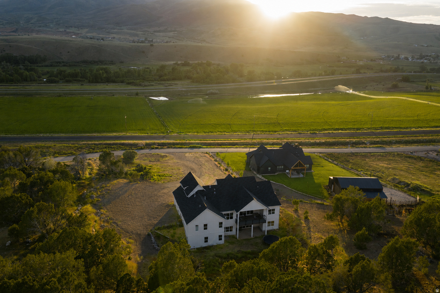 Welcome to Cottonwood Canyon, one of the Wasatch Back's best-kept secrets, where privacy, open space, and mountain living come together just minutes from Park City. Situated on 2 ACRES and backing directly to 80 acres of permanently protected open space, this exceptional 2024 custom estate offers over 6,200 square feet of thoughtfully designed living space, panoramic mountain and valley views, and unmatched flexibility. The spacious rambler floor plan features 6 bedrooms, 6 bathrooms, multiple gathering areas, dedicated office space, and a fully finished walkout lower level. Expansive windows fill the home with natural light, while the open-concept design centers around a beautifully appointed chef's kitchen with premium finishes, oversized walk-in pantry and generous workspace for entertaining. The luxurious primary suite offers a spa-inspired bath with a separate soaking tub and shower. A standout feature is the brand-new 1,780-square-foot accessory dwelling unit with its own private entrance, full kitchen, oversized walk-in pantry, dedicated laundry, 2 bedrooms, and 2 bathrooms-ideal for multigenerational living, guests, or long or short-term rental income opportunities. Enjoy peaceful outdoor living and plentiful afternoon shade on the covered deck or patio with a backyard of nothing but rolling hills, abundant wildlife, and breathtaking sunsets. Perfectly suited for horse owners, the property offers ample room for a pasture and outbuildings. Included with the property is a full share of Hoytsville Irrigation Company for secondary water and an owned culinary well water right, providing exceptional flexibility for landscaping, equestrian use, hobby farming, and future additions. Combining luxury, privacy, valuable water rights, protected open space, and income potential, this rare Cottonwood Canyon estate offers a mountain lifestyle that is increasingly difficult to find so close to Park City, a true one of one opportunity. Buyer to verify all information.