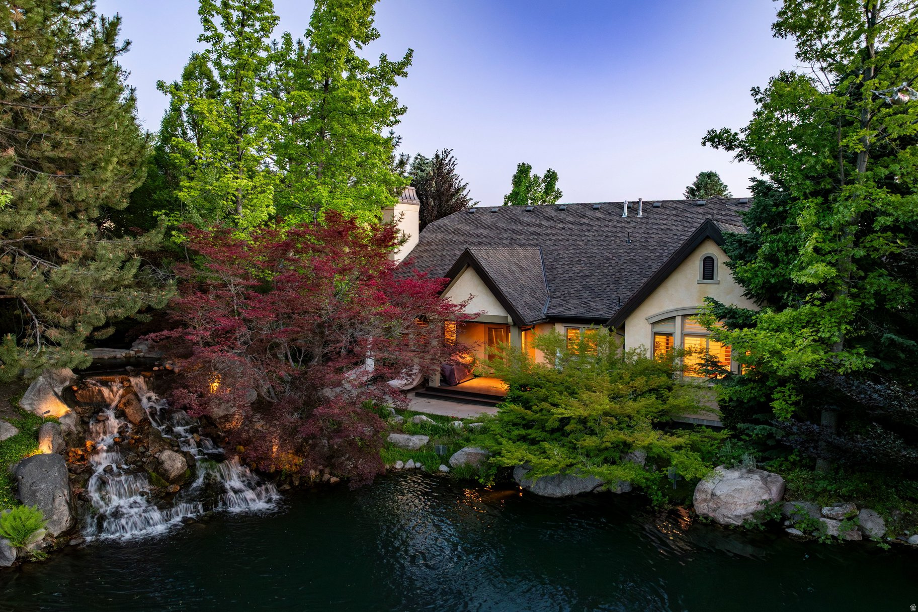 Set within the exclusive gated community of Monte Luca, this beautifully appointed residence offers elevated main-level living in a tranquil, picturesque setting defined by mature landscaping, peaceful water features, and timeless design. Step inside to vaulted ceilings with exposed wood beams, rich hardwood plank flooring, and thoughtfully curated finishes throughout. The gourmet kitchen has granite countertops, stainless appliances with a warming drawer, a gas range and a window above the kitchen sink that looks onto the pond. The kitchen opens up to the dining area and great room, where striking custom built-ins frame the fireplace and create a warm yet refined gathering space. The primary suite is grand with a spacious bedroom with soaring vaults and large windows looking out to the pond. The bathroom has marble countertops, double sinks, a walk-in shower, jetted tub and a walk-in closet with an island in the middle for maximum storage and convenience. The laundry room is also on the main level, so the livability and access of all items on the main level is perfect. Found in the lower level you have high ceilings, a workout area, two more bedrooms, one of which was converted to a craft room/office. The family room has another beautiful fireplace that anchors the space, a kitchenette with breakfast bar is great for guests staying or movie night. Outdoor spaces feature a covered deck and patio areas overlooking the peaceful pond, ideal for quiet mornings, evening dining and effortless entertaining. Other features include: a reverse osmosis water system, new paint on the walls throughout, epoxy coating on the garage floor and ample storage in the home & garage. Residents of Monte Luca enjoy an exceptional lifestyle with gated privacy, impeccably manicured grounds, and access to the community clubhouse, all within one of Cottonwood Heights' most coveted settings. Ideally located near Big and Little Cottonwood Canyons for Alta, Snowbird, Solitude & Brighton ski resorts, Willow Creek Country Club and a quick commute to Salt Lake City and the International Airport.