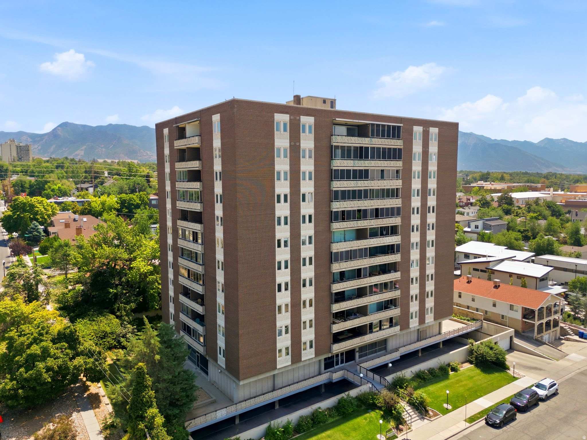 WELCOME to elevated city living at The Aztec, where breathtaking mountain & valley views meet a beautifully renovated home in one of Salt Lake City's most iconic mid-century high-rise communities. Perched on the 7th floor, this exceptional residence offers the perfect blend of modern luxury, lock-and-leave convenience, & an unbeatable location just minutes from Downtown, the University of Utah, TRAX, hospitals, dining, shopping, and countless outdoor recreation opportunities*ENTERTAIN in the stunning chef's kitchen, completely remodeled in 2018 with custom soft-close cabinetry, an oversized island, quartz countertops, designer tile backsplash, under-cabinet lighting, built-in pantry storage, coffee bar, and premium appliances including a Bosch induction range, Bosch dishwasher, Whirlpool microwave, and Frigidaire refrigerator. Beautiful white oak hardwood flooring flows seamlessly throughout the main living areas. RELAX in the bright, open living and dining spaces where expansive upgraded floor-to-ceiling windows frame incredible Wasatch Mountains & valley views. Now step onto the spacious covered balcony to enjoy morning coffee, evening sunsets, or front-row seats to Utah's changing seasons from the comfort of your own home*RETREAT to the thoughtfully updated primary suite featuring, upgraded lighting, remodeled bathroom with modern fixtures, quartz vanity, and a beautifully tiled walk-in shower. The generous guest bedroom offers double closets, & easy access to the renovated second bathroom*UPGRADES include extensive improvements including a 2018 kitchen remodel, bathroom renovations(2024), new carpet(2025), updated bedroom windows(2016), upgraded sliding patio doors, updated lighting with dimmers, remote-controlled shades, modern hardware, built-in cabinetry, & water heater(2022). New washer & dryer included!*ENJOY the peace of mind that comes with significant recent building improvements. Special assessment has been paid in full for major building updates including fire sprinkler installation, elevator modernization, common area improvements, & the upcoming fitness center renovation. HOA dues cover water, sewer, trash, snow removal, landscaping, secure building access, cable, high-speed fiber internet availability, & more, creating an easy, low-maintenance lifestyle*LOVE the convenience of private parking, additional storage, community gardens, bike storage, beautifully maintained grounds, & a friendly community while just moments from Downtown Salt Lake, 9th & 9th shopping district, the University of Utah, & world-class skiing, hiking, restaurants, & entertainment*THIS HOME offers a rare opportunity to own a fully remodeled residence with spectacular views, designer finishes, premium appliances, extensive building upgrades, & an unbeatable location in one of Salt Lake City's classic high-rise communities. Truly move-in ready!