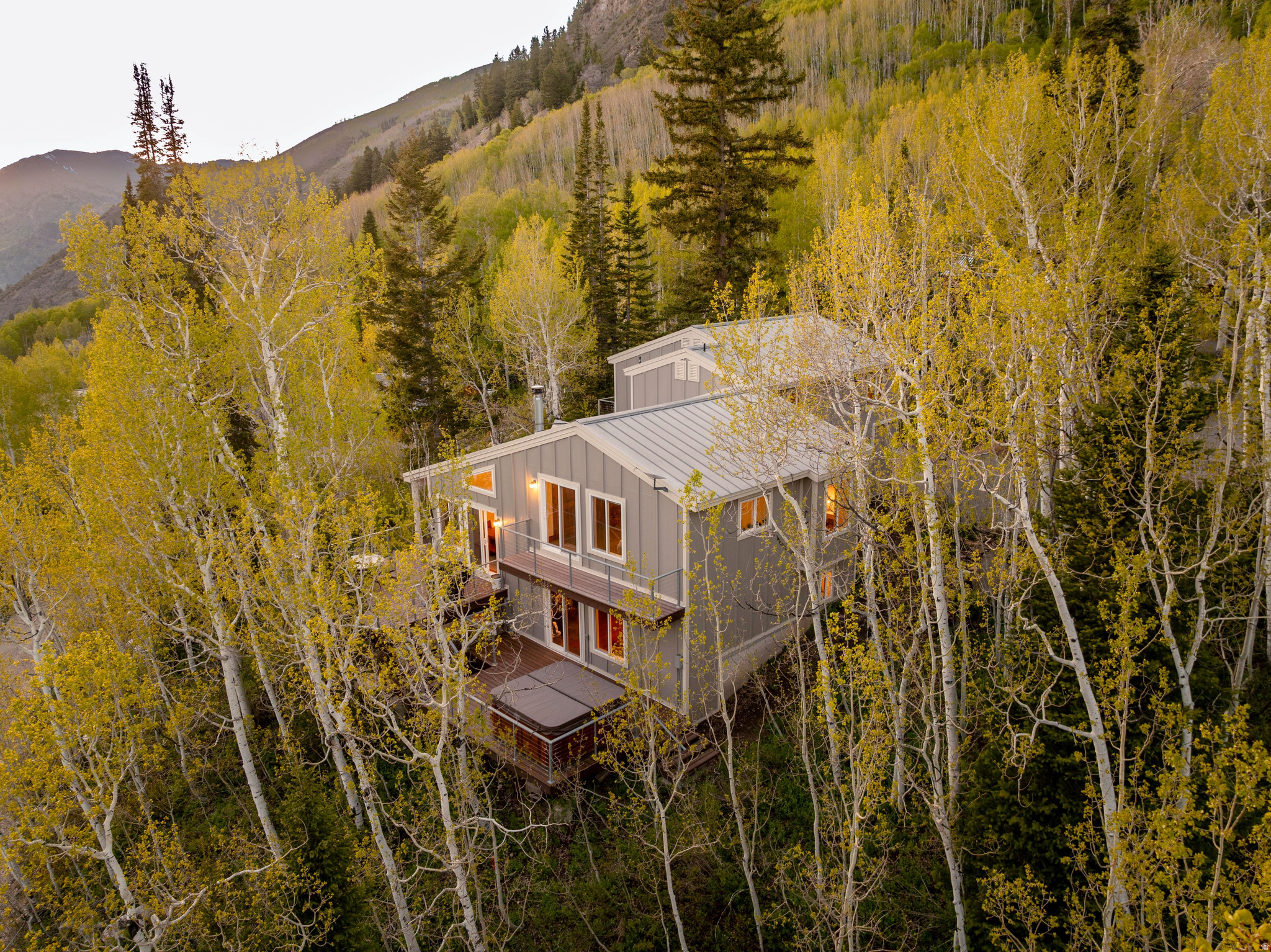 Experience a true mountain retreat tucked away in coveted Big Cottonwood Canyon. Perfectly positioned on the sunny side of the canyon, the home captures breathtaking alpine views with expansive windows and multiple decks and balconies showcasing Solitude Resort, Mt. Raymond, and Gobblers Knob. Inside, an open-concept layout is designed for comfort and entertainment. The inviting family room features a wood-burning fireplace, beautiful views, and direct access to the deck and hot tub, flowing seamlessly up to the kitchen and dining areas. The kitchen offers abundant cabinetry and generous prep space, creating the perfect gathering hub. The spacious primary suite is a peaceful retreat with a sitting area, private balcony, and large ensuite bath with dual vanity and shower. A charming bunk room sits just off the primary suite, while two additional bedrooms, two more full baths, and flexible living areas provide space for guests, a home office, or recreation. The fully finished lower level adds additional gathering space ideal for movie nights and entertaining. $200,000 in recent updates include interior and exterior paint, new exterior siding, added insulation, updated lighting, Pella windows throughout, and new washer, dryer, and dishwasher. Indoor/Outdoor living with decks and balconies designed to enjoy the mountain air year-round. Walk up the road to Willow Lake, dine at Silver Fork Lodge, and enjoy easy access to Guardsman Pass, the Brighton Loop, and world-class recreation. An attached two-car garage leads to a convenient mudroom. Property consists of two parcels, totaling .55 acre; reliable and great-tasting Silver Fork water share. Rarely does a property combine privacy, scenery, and proximity to the best of the Wasatch Mountains so seamlessly.  Agent Related to Seller. This is mountain living at its finest.
