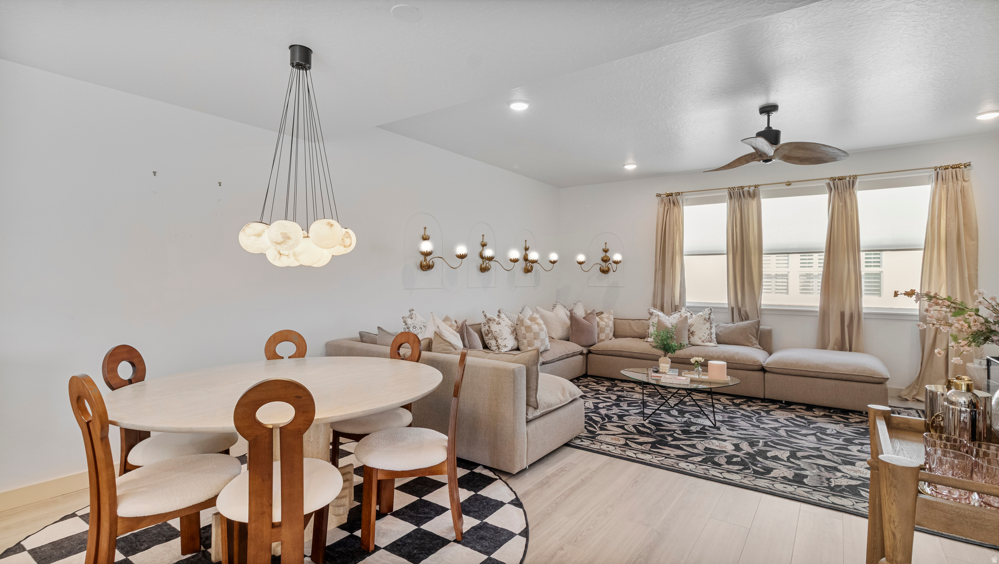 Experience a level of luxury rarely offered in a rental. This exquisitely fully furnished townhome has been professionally designed from top to bottom, creating a space that feels more like a custom luxury residence than a temporary place to live. Every detail was intentionally curated - from the elegant lighting and rich gold hardware to the designer wallpaper, custom drapery, upscale linens, and sophisticated high-end furnishings that elevate every room.  For those who have always admired beautifully designed homes but never had the opportunity to live in one, this is your chance to step into that lifestyle instantly (without the cost, time, or stress of furnishing and designing it yourself). Simply bring your clothes and begin living, hosting, and relaxing in a space that feels refined, elevated, and effortlessly luxurious.  The thoughtfully designed floor plan offers 4 spacious bedrooms, including 2 private ensuites, making the home ideal for comfortable living, guests, or multigenerational needs. The open balcony with a firepit creates the perfect setting for evening conversations, quiet mornings, or entertaining under breathtaking mountain views.  Perfectly situated near Mountain View Village; filled with restaurants, boutiques, and major retailers. The location offers both convenience and lifestyle. Enjoy quick access to Bangerter and Mountain View Corridor while still being tucked away in a peaceful, quaint setting that feels private and exclusive.  Complete with a 2-car garage, designer finishes throughout, and panoramic mountain scenery, this is more than a rental, it is an experience designed for those who appreciate beauty, comfort, and the finer things in life.