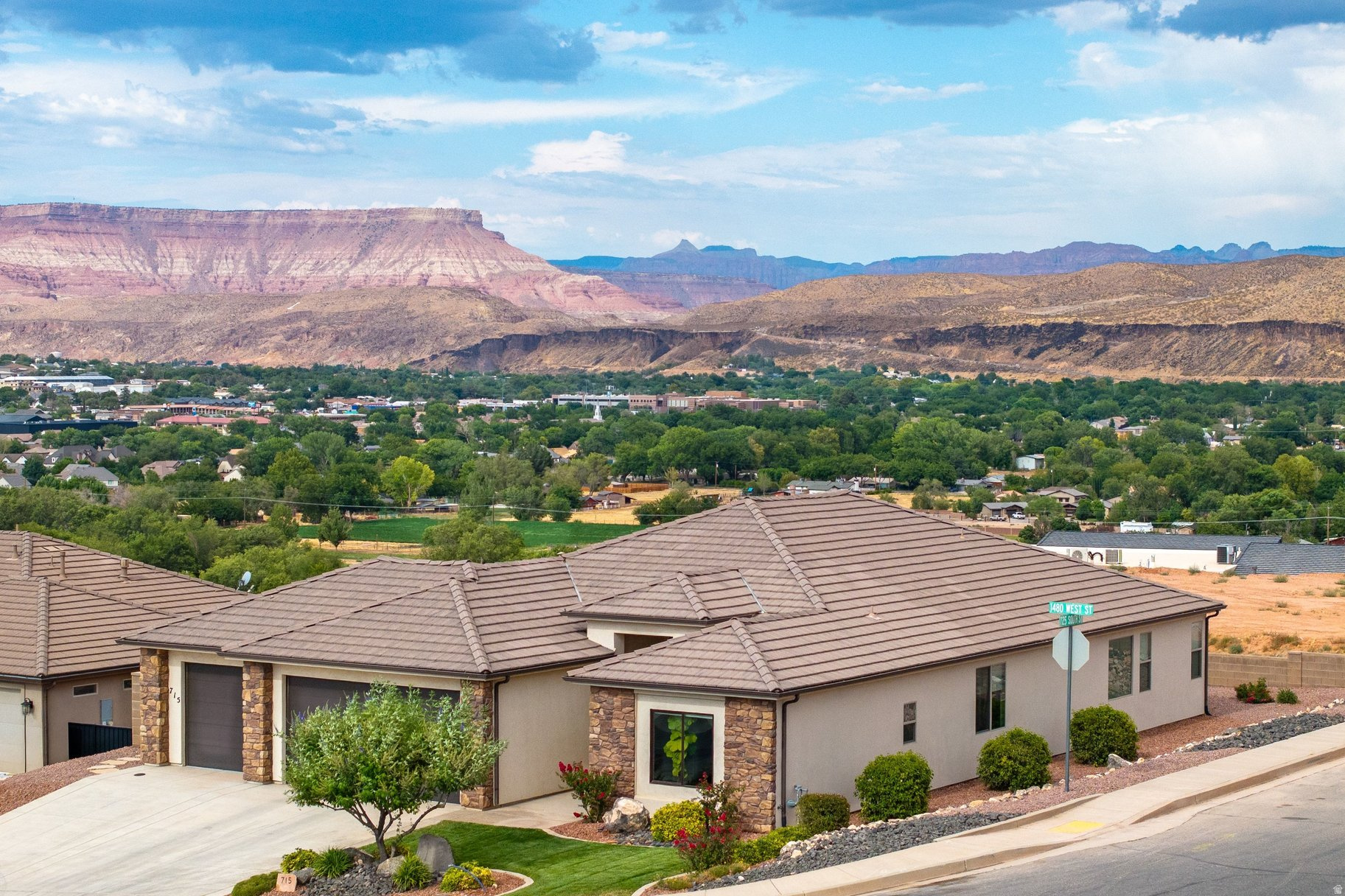 Like-new Scenic Pointe home with spectacular mountain and valley views in one of Hurricane's most desirable neighborhoods. This beautifully maintained single-level home features a bright open-concept floor plan filled with natural light, creating an inviting space for both everyday living and entertaining.  The thoughtfully designed kitchen offers upgraded cabinetry, a spacious walk-in pantry, abundant storage, and flows seamlessly into the dining and living areas. Ceramic tile flooring, a large laundry room, an oversized three-car garage with a durable epoxy floor, recently upgraded plumbing and lighting fixtures, and finished landscaping add style, quality, and functionality throughout.  Step outside to the expansive covered patio and enjoy breathtaking views of the Hurricane Valley, Pine Valley Mountain, and the stunning red rock landscapes stretching toward Zion National Park. Whether you're enjoying your morning coffee, entertaining friends, or stargazing under Southern Utah's clear desert skies, this outdoor living space is truly exceptional.  Ideally located just minutes from Sand Hollow Reservoir, championship golf, hiking and biking trails, and Zion National Park, this move-in-ready home offers the perfect combination of modern comfort, low-maintenance living, incredible scenery, and no HOA restrictions-making it an outstanding opportunity to enjoy the very best of Southern Utah living.