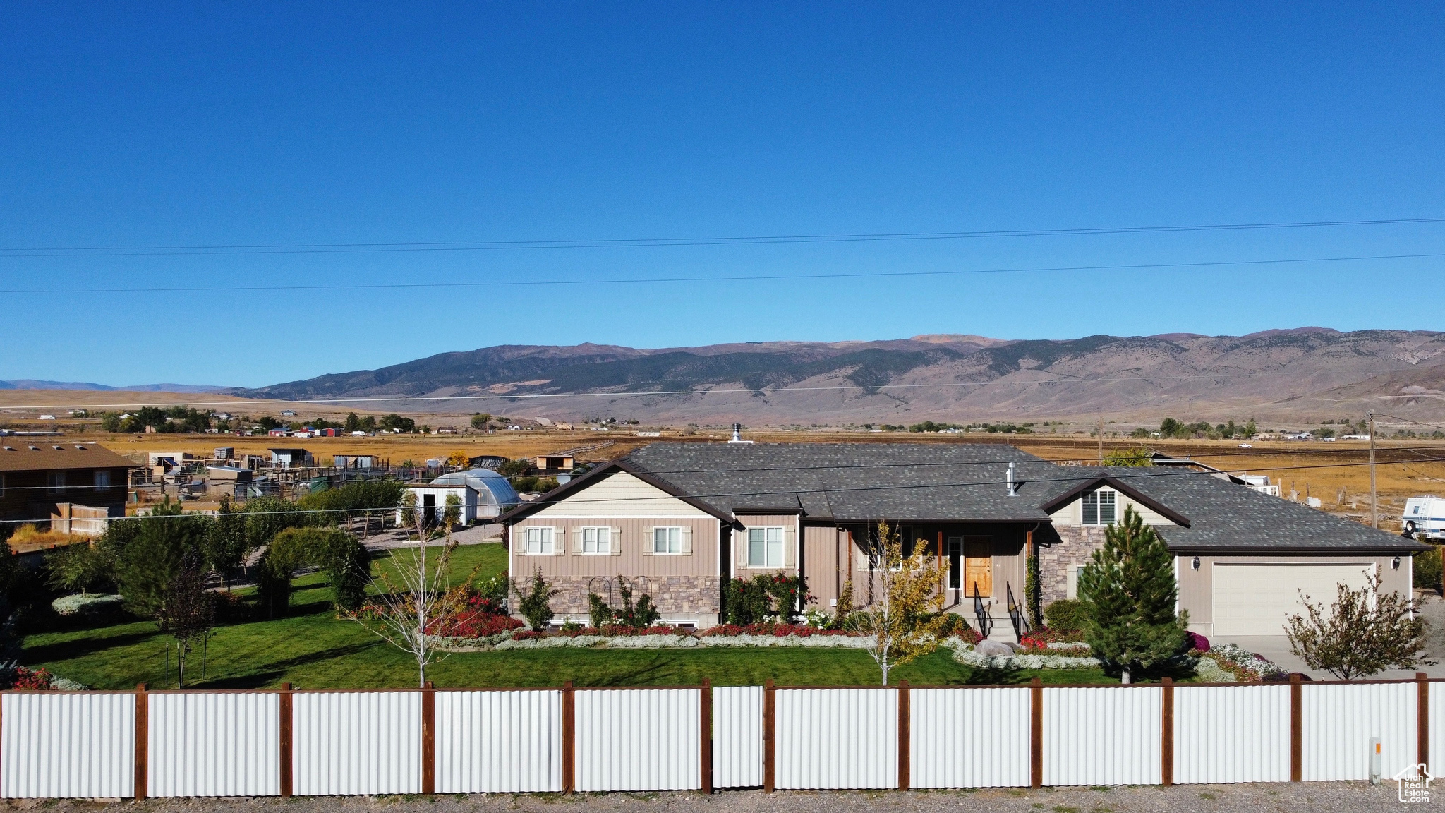 Welcome to an extraordinary estate in the heart of Monroe, Utah! This immaculate 3,990 sq. ft. home sits on just over 5 pristine acres, offering both luxurious living and the perfect touch of country charm. Surrounded by breathtaking mountain views, this property is truly one of a kind. Step inside to an open-concept floor plan where the kitchen and living room come together beautifully-featuring custom cabinetry, double ovens, an oversized island, and a gorgeous gas fireplace as the centerpiece of the space. The home offers 8 spacious bedrooms and 4 bathrooms. Step out onto the private back patio and take in views that will take your breath away. The partially finished basement with a separate exterior entrance allows you to customize the space to fit your needs-whether it's a game room, gym, home theater, or additional bedrooms. Outside, the property shines with a meticulously landscaped yard, vibrant flower beds, and a secluded setting surrounded by mature trees. For gardening and homesteading enthusiasts, you'll love the vegetable garden, berry patch, herb garden, two greenhouses, and 18 thriving fruit trees. The property comes with 3 Shares of Irrigation. The land is also equipped with 2 large heavy duty pipe corrals, perfect for equestrian use or hobby farming. An oversized three-car garage offers plenty of space for vehicles, tools, and recreational gear-providing both function and flexibility for your lifestyle. The land has plenty of space to park an RV with an RV hookup. Additional features include a wood-burning stove, ample storage, and plenty of room to roam, relax, and enjoy the beauty of nature. Located Centrally in Sevier County, this property offers more than just a beautiful home-it's a gateway to endless outdoor adventure. With easy access to world-class hiking, biking, and ATV trails, you'll enjoy year-round recreation right at your doorstep.
