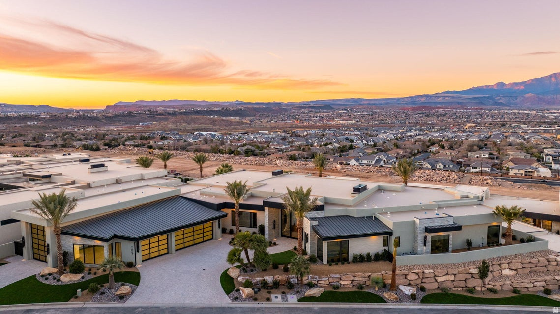 Expertly crafted by Anderson Custom Homes and masterfully curated by HGA Home, Interior Designer Julia Roberts, this 8,250-square-foot 2026 Parade Home is a bold study in contrast-light and dark, masculine and feminine, strong yet refined-coming together in a seamless fusion of modern luxury. Designed for those with a zest for fine living, walls of glass frame sweeping views of Pine Valley Mountain and Zion Canyon, allowing Southern Utah's dramatic beauty to become part of the architecture itself with forever protected views. The great room commands attention with a dramatic monolithic fireplace set beneath an architectural feature wall showcasing a 163'' LED smart TV. The brass-accented chef's kitchen is equal parts art and performance, featuring a butler's pantry, massive walk-in pantry, wine coolers integrated into the refrigerator, and a dining space anchored by a striking illuminated wine wall. A glowing quartzite powder bath adds a jewel-box moment, while a lively flex lounge sets the tone for unforgettable entertainment. The primary suite is indulgence redefined - complete with a sculptural garden soaking tub, glass walk-in shower, a separate steam shower and cold plunge tub, private sauna, and a boutique-style walk-in closet with a hidden safe room. A private casita with kitchenette offers elevated guest accommodation, complemented by thoughtful luxuries including a dog wash and home gym. Finished with an oversized 3-car garage attached to a dedicated RV garage, and a fully outfitted workshop, this residence is a statement of craftsmanship, design vision, and effortless elevated living. Bold. Glamorous. Unforgettable. Exceptional.