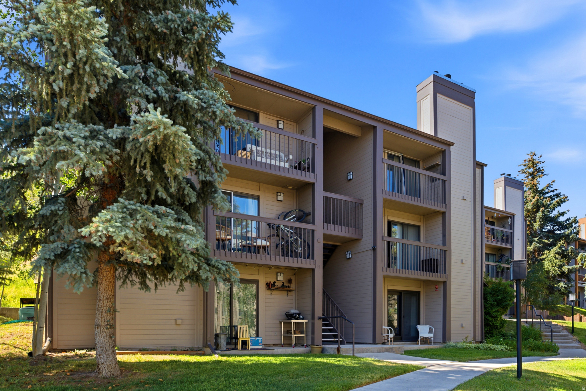 This fully furnished top-floor condo in the Fireside subdivision of Prospector offers a comfortable and well-maintained living space in one of Park City's most convenient locations. Featuring two bedrooms, two full bathrooms and 910 square feet, the layout includes an owner's en-suite, a second bedroom with a bunk bed, a cozy great room with access to a private balcony, a dining area and a functional kitchen with pantry storage. Beautiful bamboo and cherry wood hardwood flooring add warmth and character throughout, while thoughtful storage, forced air, A/C and a hallway stackable washer and dryer provide everyday convenience.  The condo also includes two assigned parking spaces, with one located close to the unit, along with guest parking for added flexibility. Ideally situated near shopping, restaurants, freeway access and within walking distance to the bus stop, also have the added convenience of a five-minute drive to both Deer Valley Resort and the Park City Mountain Village side. Whether taking your bike out for a scenic ride around Park City or enjoying easy access to dining, shops and year-round recreation, this condo is a wonderful option for experiencing the Park City lifestyle.