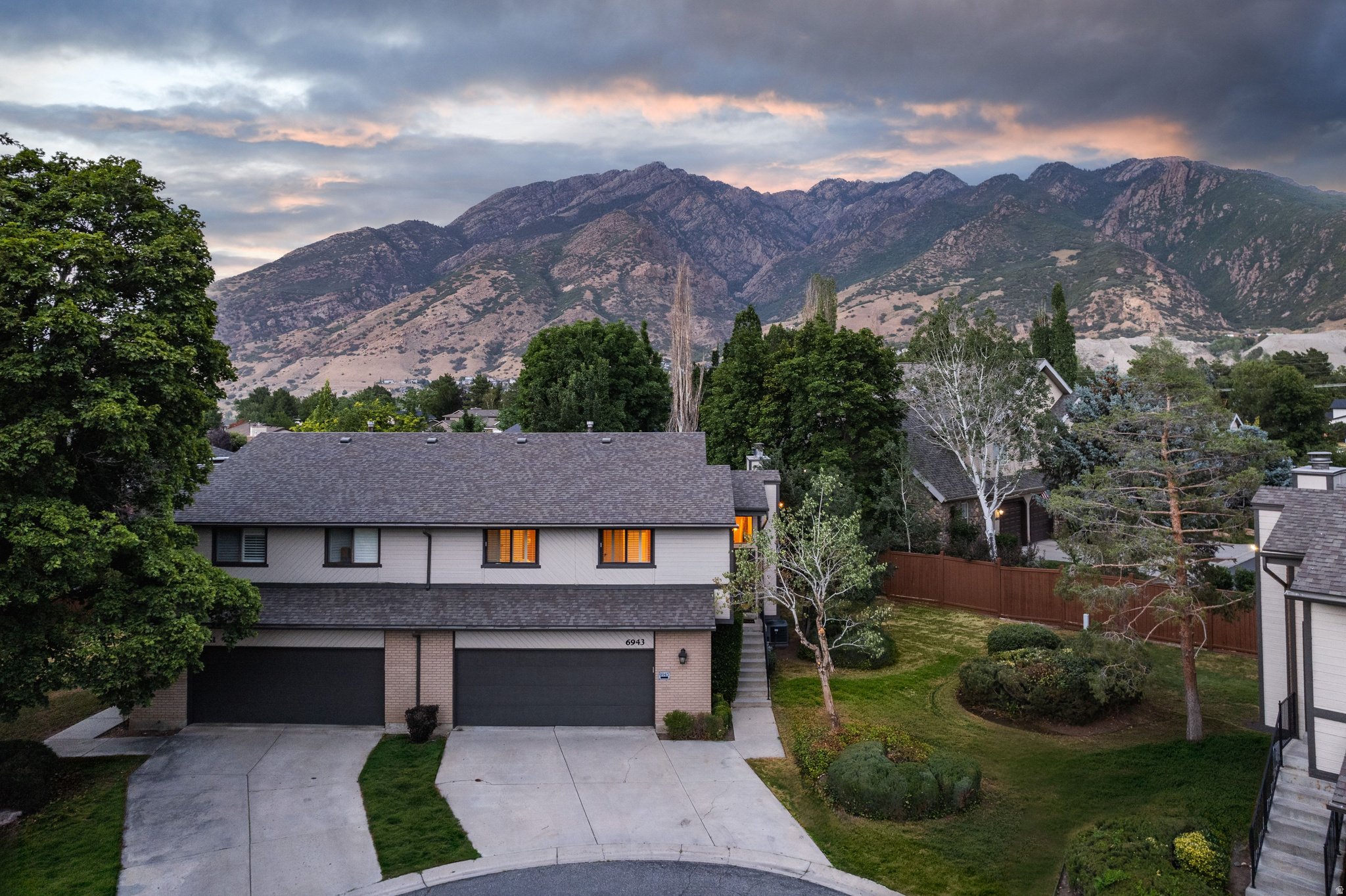 Tucked away on a quiet cul-de-sac in one of Cottonwood Heights' most desirable neighborhoods, this inviting mountain retreat offers the perfect balance of comfort, character, and outdoor living. Framed by the breathtaking Wasatch Mountains, the home places world-class recreation just minutes away, with Big Cottonwood Canyon only five minutes from your doorstep and Little Cottonwood Canyon just beyond. Inside, three thoughtfully designed levels provide flexible living spaces ideal for everyday life and effortless entertaining. Brand new LVP and carpet throughout! Two spacious family rooms, each anchored by its own fireplace, create inviting spaces to gather, unwind, or host friends after a day on the slopes or trails. Three generously sized bedrooms and two bathrooms offer room to grow, while the attached two-car garage features abundant built-in storage for skis, bikes, paddleboards, and all of your mountain adventures. Step outside and discover what truly sets this property apart. The expansive backyard-one of the largest in the neighborhood-is a private sanctuary designed for making memories. A generous deck, shaded by a pergola draped in mature wisteria, provides the perfect setting for summer dinners, morning coffee, and evenings beneath the stars. Fully fenced and surrounded by mountain views, the yard offers endless space for entertaining, gardening, pets, or simply enjoying the peaceful surroundings. Beyond the property, you'll enjoy the convenience of nearby dining, coffee shops, shopping, business centers, and quick access to I-215, making commuting throughout the Salt Lake Valley effortless. Whether your ideal weekend includes skiing fresh powder, hiking alpine trails, mountain biking, or simply relaxing in your own backyard retreat, this exceptional Cottonwood Heights home offers a lifestyle that is as adventurous as it is comfortable.