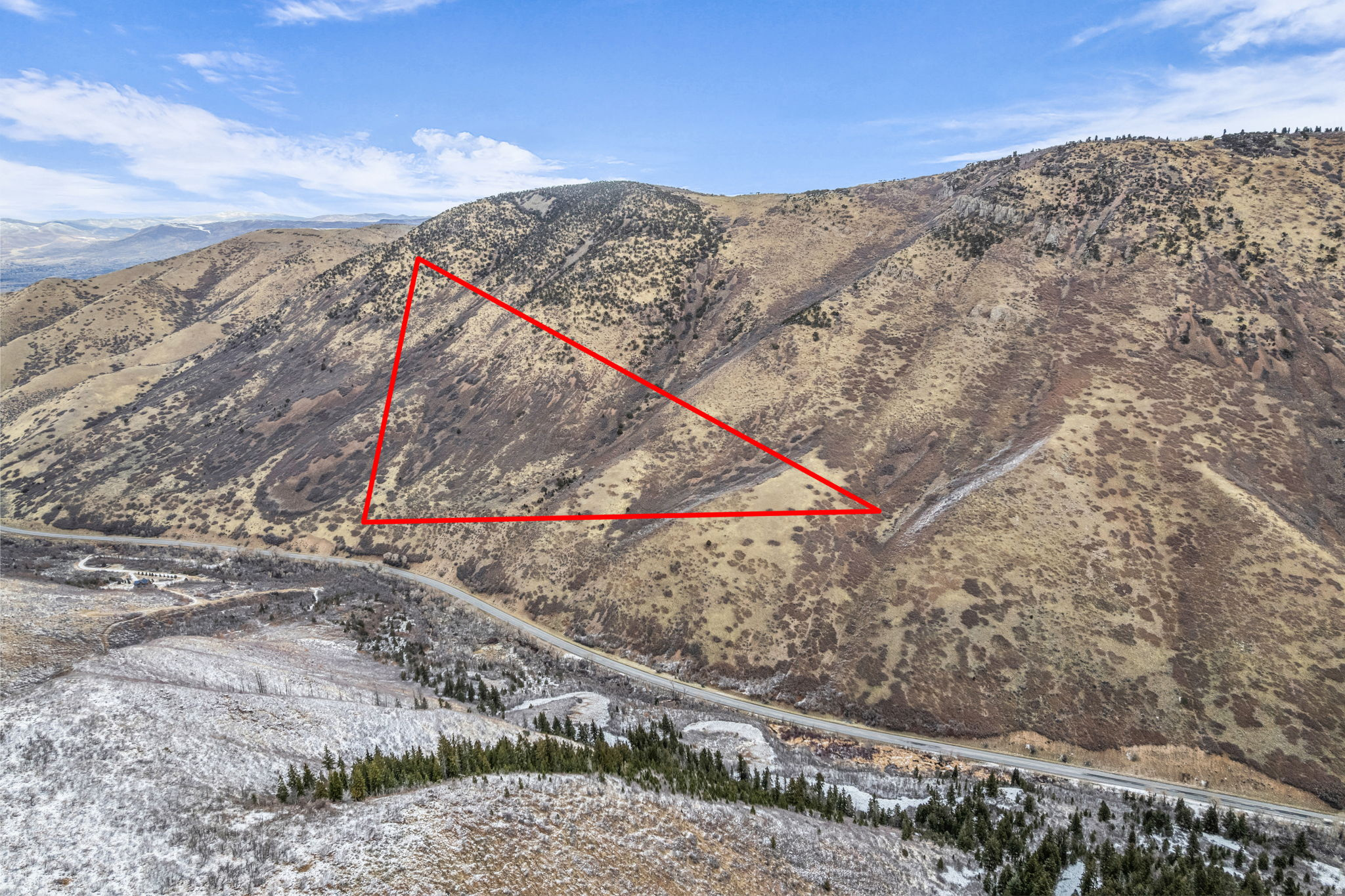Experience 261 acres of exceptional mountain land with direct frontage on Highway 40 and expansive views across the surrounding valleys and ridgelines. Zoned P-160 and already annexed into the Town of Independence, this property offers rare long-term potential.    The property features a mix of forested hillsides and open sagebrush terrain, creating a diverse landscape.  Outdoor enthusiasts will appreciate nearby access to Daniels Summit Lodge, Strawberry Reservoir, and the extensive trail systems throughout Wasatch Mountain State Park. Located just 6 miles from the Heber Valley Hospital and minutes to shopping and dining, this is a rare opportunity to secure a large, scenic acreage parcel in one of Utah's most desirable recreational corridors.
