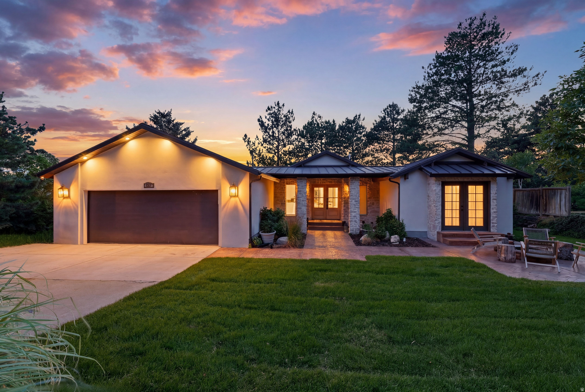 Perched among mature trees at the end of a quiet cul-de-sac, this beautifully reimagined residence offers a rare combination of privacy, warmth, and valley views. Vaulted ceilings and expansive windows flood the home with natural light while framing the surrounding landscape and sparkling city lights below. Thoughtfully designed with lime-washed walls, custom millwork, and designer finishes throughout, every space feels elevated, inviting, and timeless. At the heart of the home, the chef's kitchen was designed for gathering, featuring dual oversized islands, premium appliances, abundant storage, and seamless flow into the dining and great room spaces beneath soaring ceilings. The main level primary suite offers a true retreat with a spa-inspired bath featuring custom finishes, a freestanding soaking tub, and an oversized shower. Throughout the home, each bathroom has been thoughtfully curated with its own unique design aesthetic. The walkout lower level was built for entertaining and everyday living alike, featuring a stunning bar, dedicated home gym, bunk room, and generous gathering spaces for family and guests. Additional highlights include a thoughtfully designed mudroom, seamless indoor-outdoor living, and a setting that feels worlds away while remaining just minutes from the city below. A rare opportunity to own a design-forward retreat where luxury meets tranquility above the Salt Lake Valley.