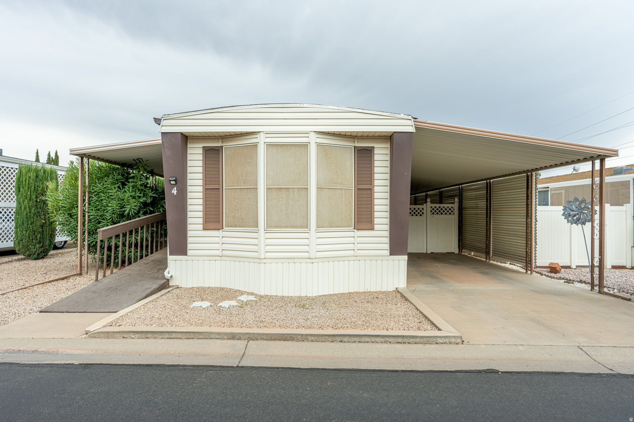Welcome to this charming 2-bedroom, 2-bath home in the desirable 55+ Paradise Palms community! This well-maintained home offers a comfortable open living area, a cozy kitchen with plenty of character, and a covered deck that's perfect for relaxing. An attached covered carport adds everyday convenience. Enjoy the comfort of low-maintenance living in this welcoming community. Don't miss your chance to make this home yours!