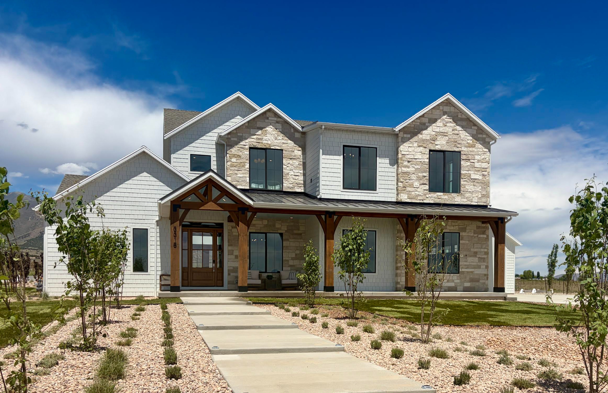 The Brin Valley Ranch is a refined ranch-style estate that blends contemporary luxury with timeless heritage design, thoughtfully positioned on an expansive homesite of over an acre and a half-with sweeping mountain views. Designed for both everyday living and elevated entertaining, the home features 10-foot ceilings on the main and upper levels, a dramatic great room with soaring ceilings (over 20-feet), and seamless indoor-outdoor living spaces that showcase the surrounding landscape. At the heart of the home, a chef-inspired kitchen with an adjoining prep kitchen creates the perfect gathering space, while the grand primary suite offers a spa-like retreat complete with an elevated wet room experience. Two oversized two-car garages (accommodating up to four vehicles total) are connected by a breezeway, which leads to a separate entrance for the fully finished basement Accessory Dwelling Unit. The beautifully finished ADU adds exceptional flexibility and includes 3 bedrooms, 1 bathroom, a full kitchen, dining area, comfortable living room, pantry, and dedicated laundry room. Designed for true ranch living, the property also features a spacious outdoor deck, a fully fenced arena, and two livestock shelters equipped with a non-freeze automatic watering trough. Life at Firefly Ranch extends far beyond the home itself. Created for those who value space, freedom, and connection to the outdoors, this unique acreage community offers direct access to community bridle paths that connect to BLM open space, providing endless opportunities for horseback riding, trail exploration, and outdoor adventure right from your backyard. Inspired by Cedar Valley's western heritage and rodeo culture, Firefly Ranch embraces outdoor living and responsible animal ownership with one of the area's most generous animal-friendly HOA policies. This homesite allows up to 8 horses, 6 small livestock animals-including goats, sheep, pigs, and roping calves, and 20 chickens. Residents also enjoy exceptional community amenities, including a skate park, pump track, pickleball and basketball courts, playgrounds, trails, downhill mountain biking trails, and weekly events led by the community's full-time Activities Director. Firefly Ranch offers a rare opportunity to experience luxury living with the freedom, space, and lifestyle today's families are searching for.