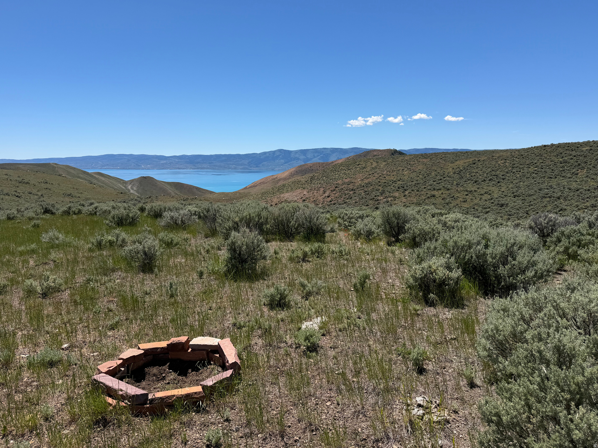 Super neat opportunity for a sweet lake view lot where you can either camp or build a cabin, with 40 acres of room, for under $150k! Quite flat through most of it, with only a gradually sloping hill where it's not flat. Located on east side of Bear Lake, access and frontage on two county roads - Flat Rd and Mud Springs Rd (property located just ~250 yards SW of intersection of Flat and Mud Springs Rd), so no issue with needed easements or ambiguity of access like many similar recreational/ag lots! Borders thousands of acres of public BLM land to the west with trails to ride! Only 15-18 minute drive to North Beach or East Beach State Parks! New fence on south side. No county winter maintenance on said county roads. There is quite a bit of sagebrush, but plentiful areas of good natural grasses if planning to use it for range/grazing ground, too! Best lakeview/camping spot is on yellow star in attached picture, ~80% of the way to the west of the property, and though no driveway has been cut in to the west side, enough sagebrush has been removed to drive to it in standard vehicle pulling camper. Make sure to check out the lake views from that west end when viewing property! Seller to have dirt road cut in before closing with good offer! Power is not nearby, and buyer to install well and septic if desired. Call and check it out today!