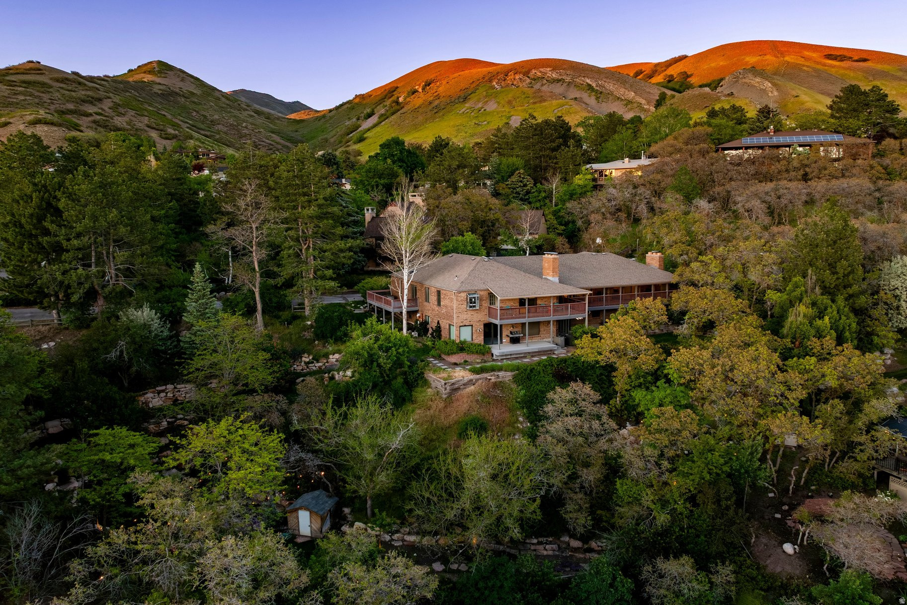Tucked into an extraordinary .85-acre setting in Arlington Hills, this private hillside retreat captures sweeping valley and mountain views that feel worlds away from the city, yet sits just minutes from the University of Utah, downtown Salt Lake, and foothill trails. Built into the landscape with a walkout lower level, the home offers generous living spaces, five bedrooms, three baths, three fireplaces, and two laundry areas. The main level features vaulted ceilings, large windows framing the views, and seamless access to outdoor living spaces designed to take full advantage of the setting. Multiple patios, mature landscaping, and a fire pit create an incredibly peaceful, tucked-away atmosphere rarely found this close to the city. Thoughtful updates have been completed over the years, while the property still offers tremendous opportunity to personalize and reimagine the space. Architectural renderings showcasing the home's potential future transformation are available upon request. An incredibly rare setting that feels secluded, yet connected to everything.