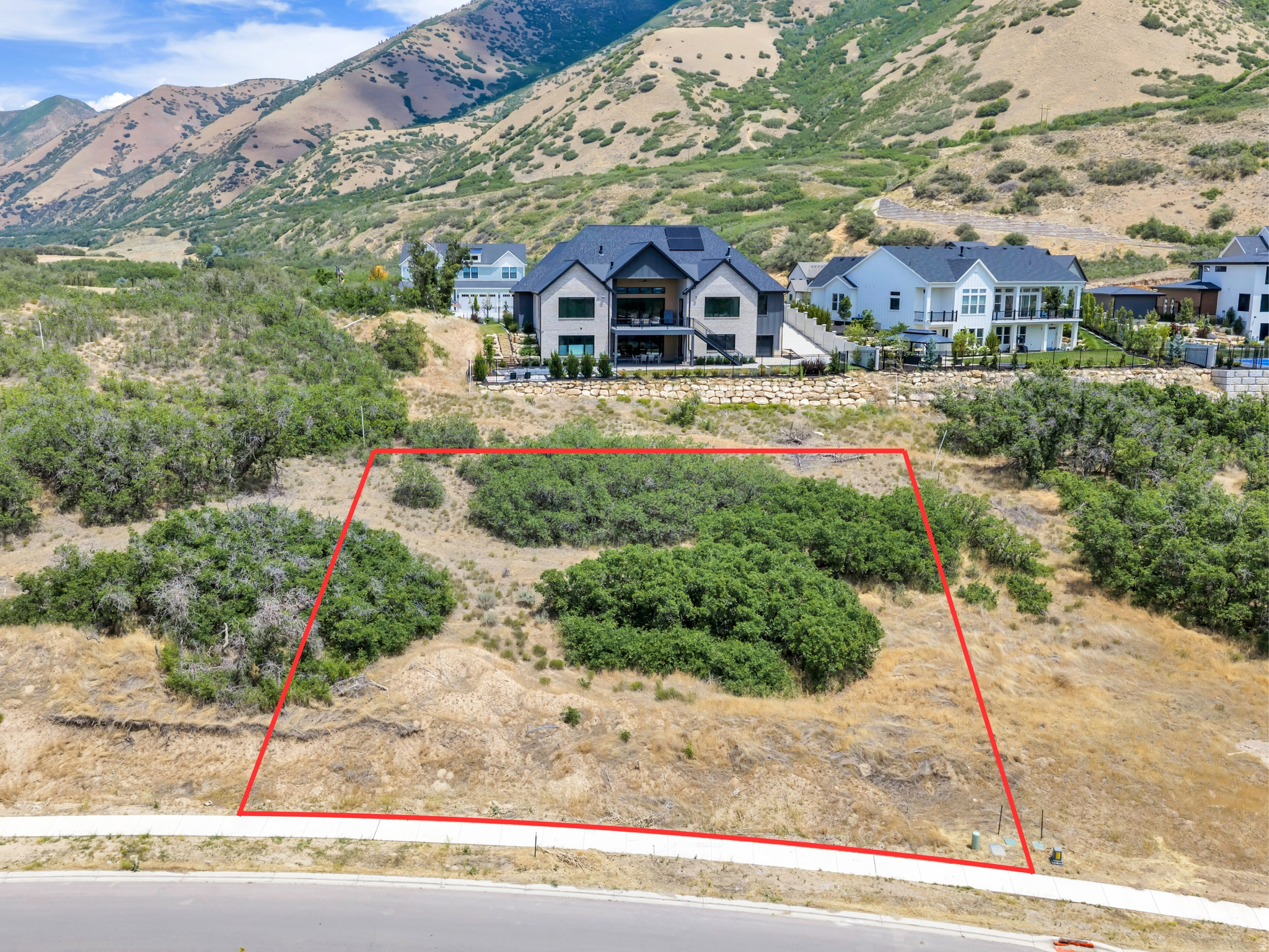 Lot 18 in Twin Hollow is a 0.38-acre parcel at the base of the Wasatch Mountains in Mapleton, ready for a custom build in an established neighborhood of high-end homes. The lot has direct mountain views to the east and valley views to the west. The Mapleton Parkway Trail runs nearby, covering 6.1 miles between Springville and the mouth of Spanish Fork Canyon for cyclists, walkers, and equestrians.