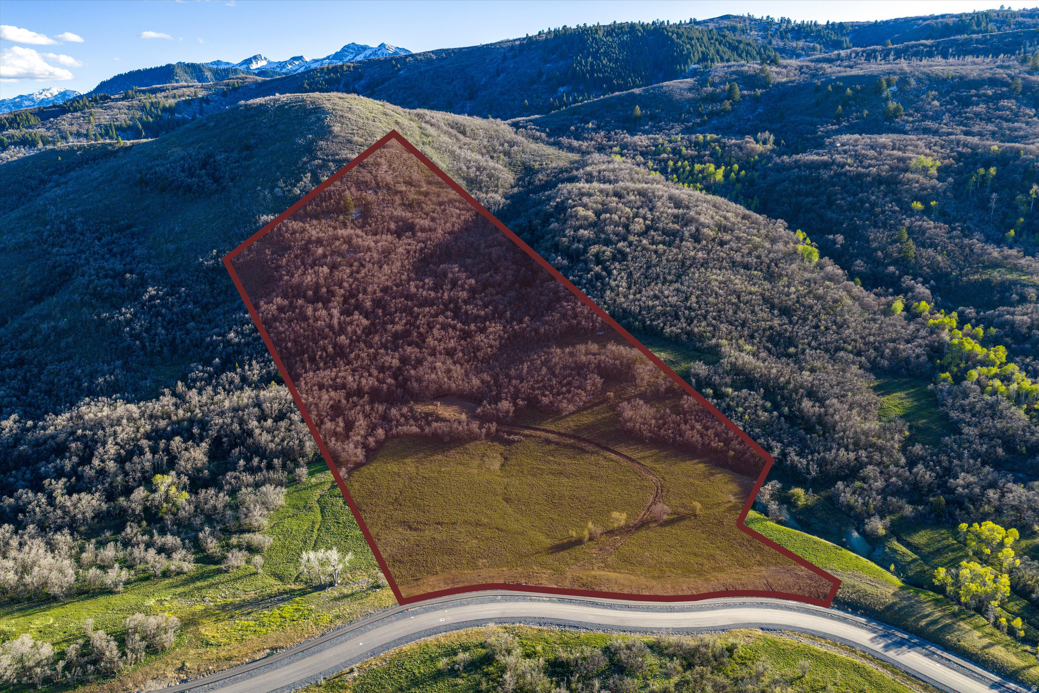 Welcome to Osprey Ranch, an extraordinary 600-acre mountain community at the gateway to year-round recreation in scenic Eden, Utah. This remarkable 18.74-acre homesite offers a peaceful, wooded setting with mature oak, pine, and aspen trees. It backs directly to Forest Service land for unmatched privacy and open space. With utilities in place, the lot is ready for you to design and build your dream mountain retreat. Osprey Ranch is an exclusive community of just 67 homesites, perched above the northwestern shores of Pineview Reservoir and surrounded by over 10,000 acres of protected national forest, where breathtaking alpine landscapes meet refined mountain living. Enjoy both seclusion and convenience, located just 4 miles from Nordic Valley Ski Resort and within 15 miles of world-class skiing at Powder Mountain and Snowbasin. Whether it's skiing, hiking, biking, or simply taking in the views, this property places you in the heart of Utah's premier recreation corridor. The neighboring 12.3-acre parcel to the north is also available, creating an opportunity for over 30 contiguous acres abutting protected forest,a rare depth of privacy, and open space at any price. Additional questions about Osprey Ranch can be found on their website, osprey-ranch.com Boundary lines are provided as a courtesy estimate only. Buyer is advised to obtain independent measurements.
