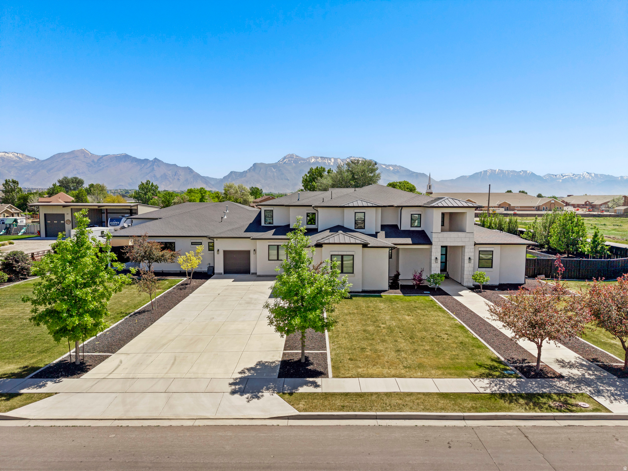 Welcome to luxury living in the heart of Lehi. This stunning estate-style home offers the perfect blend of comfort, entertainment, and functionality with expansive gathering spaces designed for hosting family and friends in style. From the moment you enter, you'll appreciate the spacious open layout, soaring ceilings, and thoughtfully designed living areas that create a warm yet impressive atmosphere. A true standout feature is the incredible indoor half-court basketball center - the ultimate year-round space for recreation, training, and unforgettable memories. The home also features a private lock-off casita complete with its own gym, providing the perfect setup for guests, multigenerational living, or a private retreat. Enjoy movie nights in the dedicated theater room, entertain effortlessly throughout the home's oversized gathering areas, and take advantage of the large lot offering endless possibilities for future expansion, outdoor living, a pool, sport court, or additional landscaping. With room to grow both inside and out, this exceptional property delivers luxury, versatility, and lifestyle all in one remarkable package.