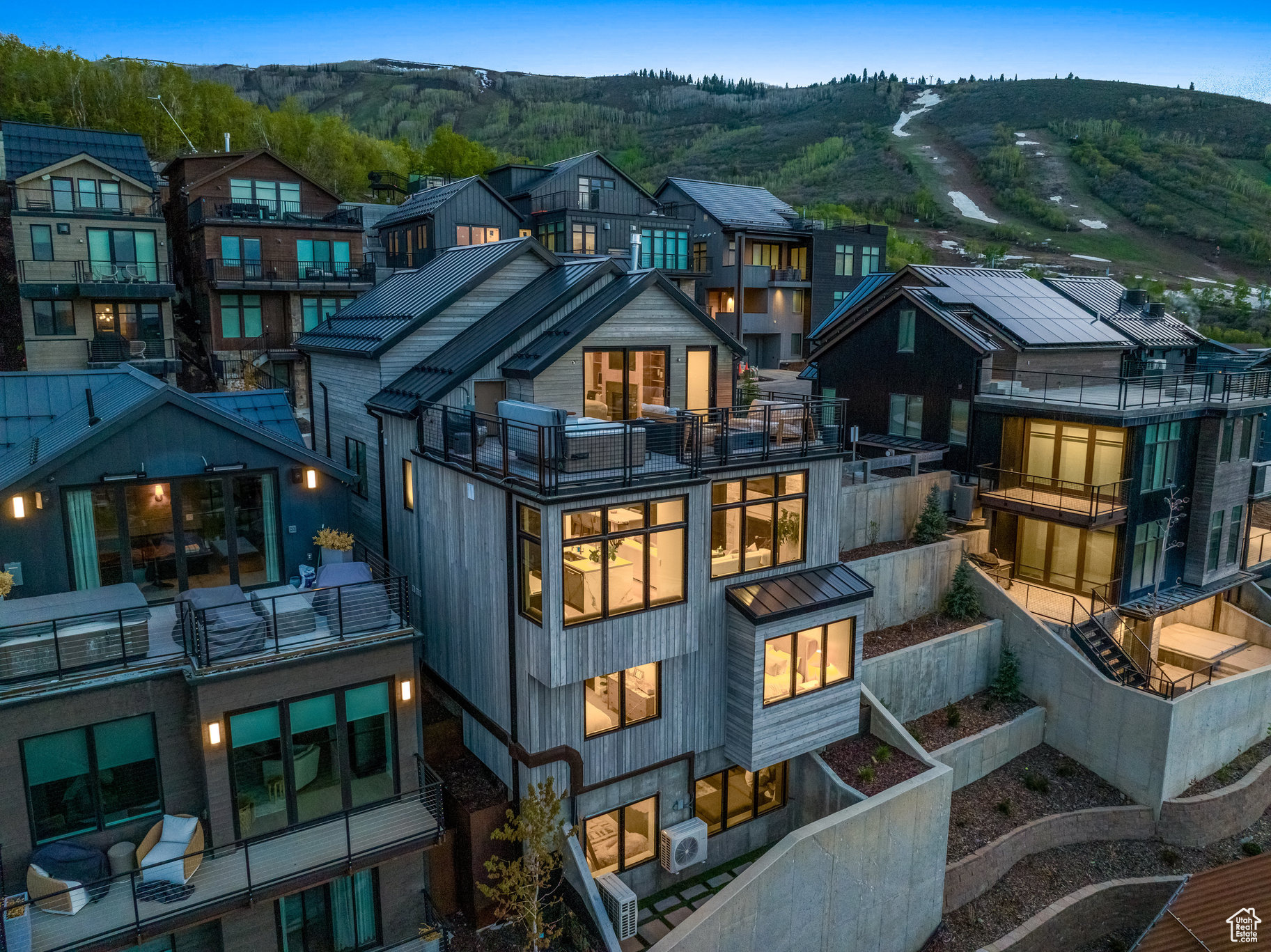 Located in Old Town Park City, King's Crown development, this recently completed five-bedroom, seven-bath residence offers the ultimate ski-in/ski-out mountain retreat. Designed by Kristen Bombeck, the home blends sophisticated design, custom finishes, and luxurious details with a thoughtful floor plan that emphasizes both comfort and privacy. Just steps from the private owner's lounge and lockers at The Tower, the home provides seamless mountain access while offering spacious, inviting interiors. Five en-suite bedrooms are positioned across multiple levels-including a top-floor primary suite with a heated rooftop deck, hot tub, and fireplace-framing views from City Park to Lewis Peak. The main level integrates copper, stone, and wood into a stylish yet warm gathering space, anchored by a chef's kitchen with quartz and marble countertops and top-of-the-line appliances. Natural light floods the interiors, enhanced by carefully curated furnishings, custom built-ins, generous storage, and Lutron automated shades. A lower-level lounge with adjacent bunkroom provides a perfect setting for movies and games, while an elevator ensures easy access to all four levels. Every detail, from flooring to countertops, has been thoughtfully selected to balance beauty and functionality. Beyond the home, four seasons of recreation await: direct ski-in/ski-out access, miles of hiking and biking trails, and proximity to Park City Mountain Resort's base village and the Park City Golf Course-all just a short walk away.