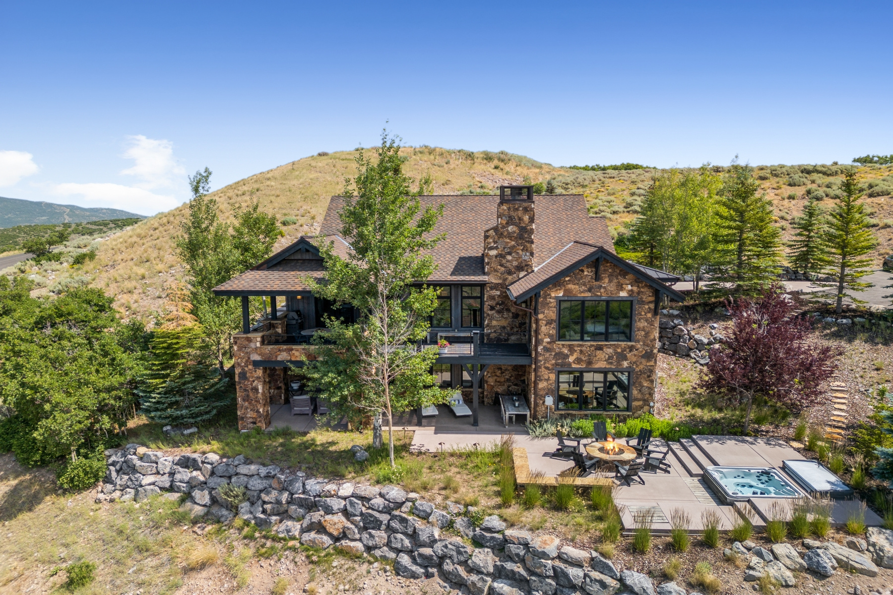 Top of the world views in Promontory -- Perched atop the mountain in the prestigious gated community of Promontory, this luxurious home offers unmatched privacy, comfort, and panoramic views of Deer Valley and Park City's iconic ski slopes. Thoughtfully designed with five spacious bedrooms and six elegant baths, the home features custom cabinetry, a chef's kitchen with premium appliances, and radiant heated floors. Enjoy year-round outdoor living with a heated deck, private hot tub, and expansive views from sunrise to sunset. Tucked at the end of a quiet cul-de-sac, this retreat is perfect for families or entertaining guests in style. A true legacy home in one of Park City's most sought-after communities.