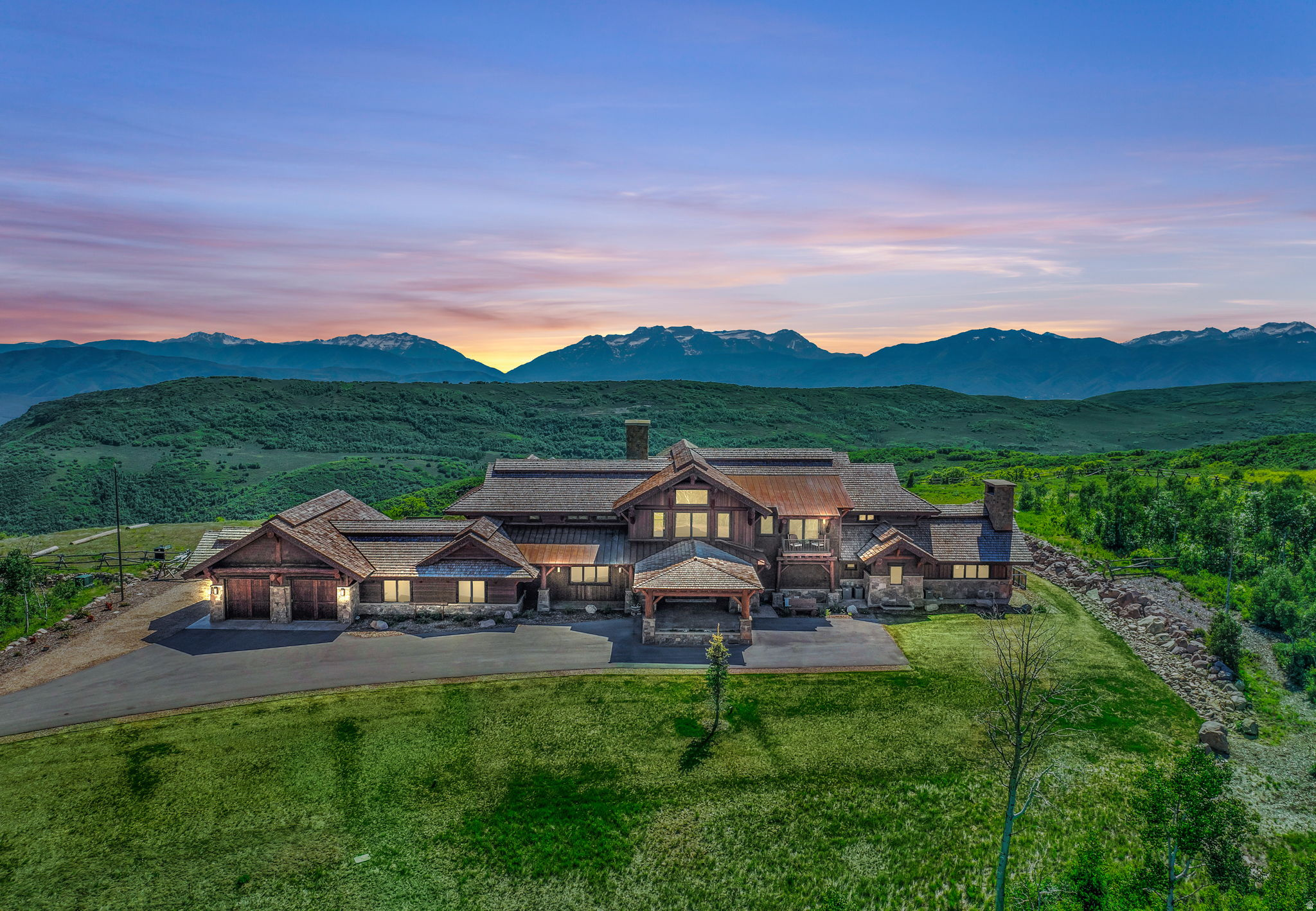 IRREPLACEABLE OPPORTUNITY: Set within the private gates of Wolf Creek Ranch, this newly built ranch spans 168 acres within a 13,200-acre mountain preserve with 94% of its open space permanently protected. Offering exceptional privacy and year-round access, all within 15 minutes of Heber City with its private airport, and under an hour to Salt Lake City International Airport. Completed in 2020, the residence was designed as a true mountain ranch compound. The dramatic great room with 36-foot ceilings frames Mount Timpanogos, while heated arrival areas welcome family and guests year-round. Eight bedrooms and eleven bathrooms provide generous accommodations without sacrificing owner privacy. The main level features a saloon-style bar, private theater, executive office, and a primary suite positioned as its own retreat. The chef's kitchen is equipped with dual Wolf professional ranges, multiple Sub-Zero refrigeration systems, and a butler's pantry built to perform at scale. Heated outdoor terraces with a fireplace and an expansive level lawn create rare hosting flexibility for celebrations, weddings, and gatherings. Wellness and security amenities include a yoga studio with steam room and dry sauna, fitness room, climate-controlled wine room, ventilated cigar lounge, two secure safe rooms, Savant whole-home automation, radiant heat, and air conditioning. For equestrian enthusiasts, the property is fully suited for ranch living. The acreage allows for additional improvements such as a private barn with stables and guest house, offering flexibility to grow into a larger private compound over time. Ownership within Wolf Creek Ranch provides access to more than 60 miles of private trails for snowmobiling, horseback riding, hiking, and ATV use. The community borders 2.2 million acres of the Uinta National Forest, includes private Upper Provo River fly-fishing access, stocked trout ponds, a ranch center for gatherings, guest lodge and yurts for owners, and a dedicated equestrian facility with horses available to ride. All this only 30 minutes to skiing at Deer Valley Resort, 35 minutes to Sundance Mountain Resort, and 40 minutes to Park City's Historic Main Street.