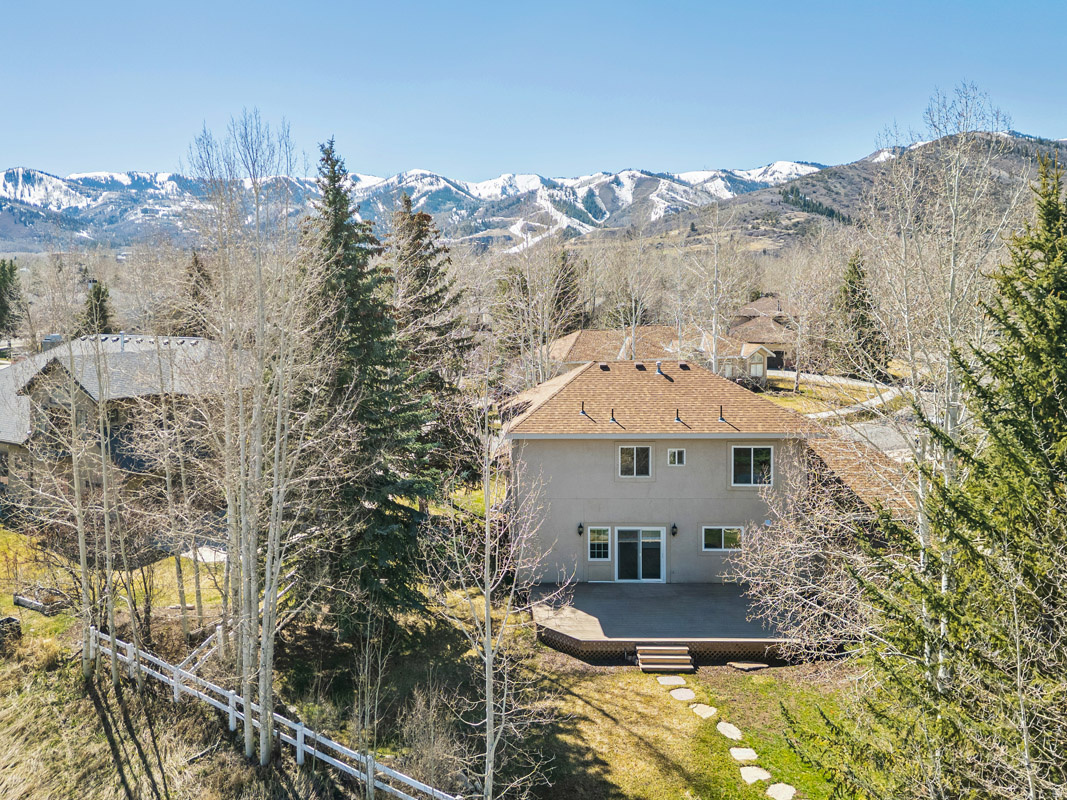 Located on a quiet street in the Snyder's Mill neighborhood, this beautifully updated home at 1429 W Rio Grande Road offers privacy, modern upgrades, and mountain views just minutes from Park City's amenities. Ideally positioned near Kimball Junction, the home provides quick access to Park City Mountain, Canyons Village, and Deer Valley Resort, along with nearby Nordic skiing and year-round recreation. Snyder's Mill borders Willow Creek Park, featuring a dog pond, playgrounds, tennis courts, playing fields, and an extensive trail system connecting Kimball Junction to Park City. Parley's Park Elementary is just steps away, within the Park City School District.  Set on a 0.26-acre lot, the home enjoys a private backyard with no future development behind. A large deck, a gas line for grilling, and an in-ground sprinkler system with app controls create easy outdoor living. From the front of the home and select rooms, take in views of Canyons Village and the surrounding mountains.  Inside, the home is bright and thoughtfully updated with a clean, modern aesthetic. The open-concept main level features new luxury vinyl flooring, fresh paint, and a gas fireplace. The fully remodeled kitchen includes quartz countertops, soft-close cabinetry, stainless steel appliances, a range hood, under-cabinet lighting, and a large island with seating. The dining area comfortably accommodates 810.  All bathrooms have been updated, including a spacious primary suite with a freestanding tub, tiled shower, and double vanity. Four bedrooms offer generous space, with new carpet throughout.  Major upgrades include new windows, two furnaces, water heater, water softener, humidifier, and washer/dryer. Plumbing has been upgraded to PEX with a transferable lifetime warranty. A three-car garage and storage shed provide ample space.  With extensive updates, a quiet setting, and prime location, this move-in-ready home offers the best of Park City living.