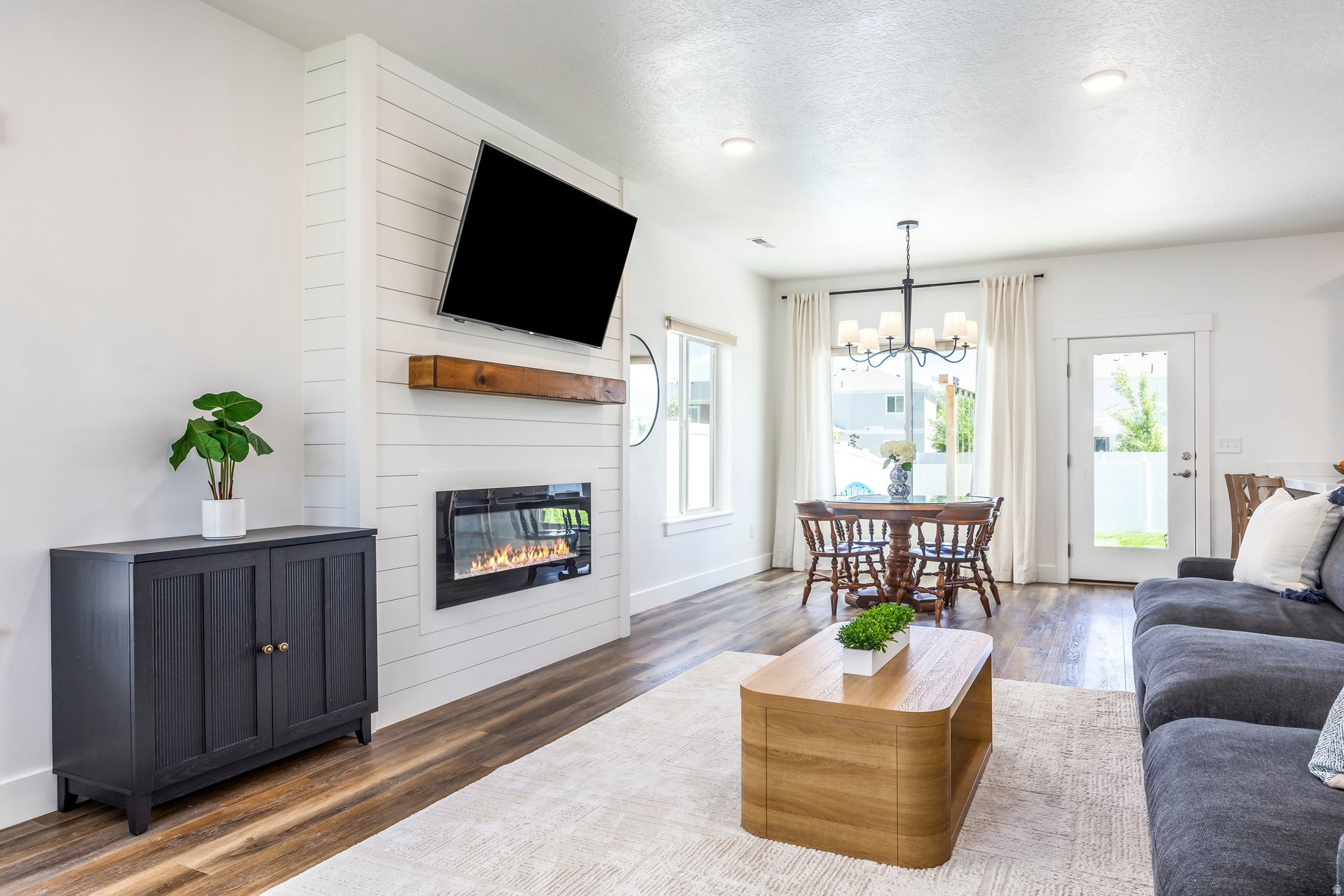 Set within Heber City's coveted Brookside neighborhood, this thoughtfully designed home captures the essence of mountain living with contemporary interiors, expansive views, and open space. A lifestyle that feels both connected and removed. Backing to protected community open space and pasture land, the setting is remarkably private, with uninterrupted views stretching across the valley to the ski runs of Deer Valley Resort and the surrounding Wasatch Mountains. The main level features vaulted ceilings and a great room with oversized windows that welcome natural light throughout the day, creating a bright and inviting gathering space. A linear fireplace framed in shiplap introduces warmth and custom character, while designer lighting, quartz surfaces, and carefully selected finishes bring a refined yet approachable aesthetic to everyday living. The kitchen is equal parts functional and beautiful, featuring shaker cabinetry, two generous pantries, double ovens, a five-burner gas cooktop with vented hood, and an oversized island designed for everything from weeknight dinners to weekend entertaining. Upstairs, the home settles into a quieter rhythm. The primary suite is positioned to capture one of the property's most coveted views, offering a direct sightline to Mount Timpanogos from the bedroom window. Framed by changing seasons and morning light, it's a view that never grows old. The suite is complemented by blackout shades, a spa-inspired bath with soaking tub and dual vanities, and a spacious walk-in closet. Three additional bedrooms and a full bath provide flexibility for guests, family, or work-from-home needs. Outdoors, the property truly distinguishes itself. An oversized patio creates an effortless extension of the living space, offering a front-row seat to open skies, mountain sunrises, and the ever-changing landscape beyond. The fully irrigated lawn provides room to play and gather, while established playground equipment makes the backyard immediately ready for family enjoyment. With no rear neighbors and open space directly beyond the fence line, the outdoor experience feels unusually expansive and is more reminiscent of a private retreat than a traditional neighborhood lot. Located just moments from Brookside's walking paths, playground, and pump track. Nightly rental eligible and within easy reach of world-class recreation including Deer Valley Resort, Sundance Mountain Resort, reservoirs, golf courses, and endless trail systems. This home offers a rare combination of newer construction, designer finishes, and one of the most compelling view settings in the community.