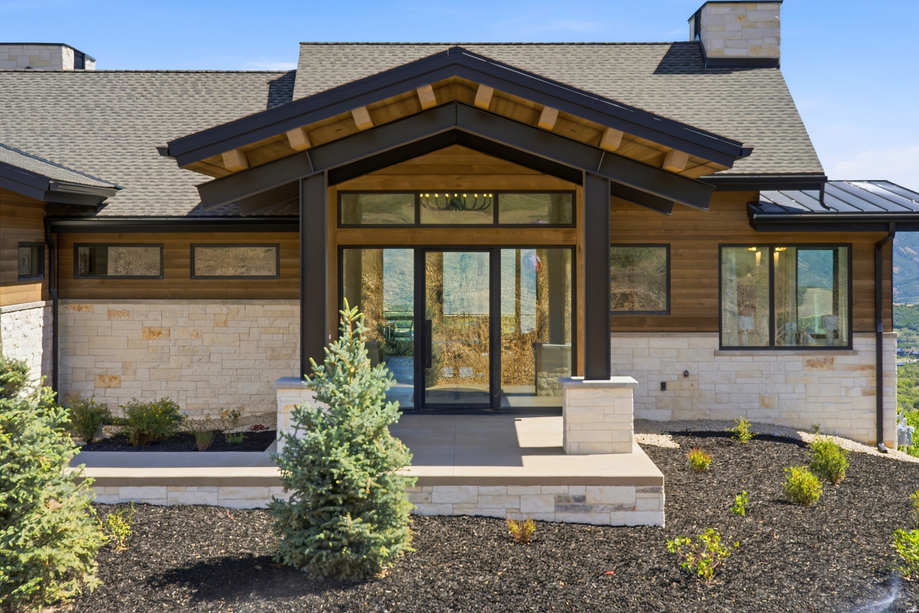 Welcome to Halo Crest. Approach a grand covered front patio leading to a full-glass front door, immediately setting the tone for the quality, scale, and sophistication found within. Set on one of the largest and most coveted homesites in the Golden Eagle neighborhood, this exceptional new construction residence represents a masterful blend of inspired architecture, elevated wellness living, and effortless indoor-outdoor design. Thoughtfully designed by Budingen Architecture and built by Jorgenson Builders, the home is defined by expansive walls of glass, grand entertaining spaces, and private bedroom retreats-all oriented to capture breathtaking views and abundant natural light. The residence offers five bedrooms, seven bathrooms, a dedicated office, a spacious mudroom, and an oversized three-car garage, providing both luxury and livability at every turn. At the heart of the home, dramatic living and dining spaces unfold with architectural intention-the dining room framed by dual glass walls, and the great room featuring a moving glass wall that dissolves into nearly 1,000 square feet of deck and patio space, creating a seamless extension of the living area for year-round entertaining. A private wellness center elevates the home to resort-level living, complete with a workout area, sauna, cold plunge, and  bathroom-designed for restoration and daily balance.  Halo Crest is a rare opportunity to own a newly built architectural statement on an oversized lot in Golden Eagle-where refined design, privacy, and views come together in perfect harmony.