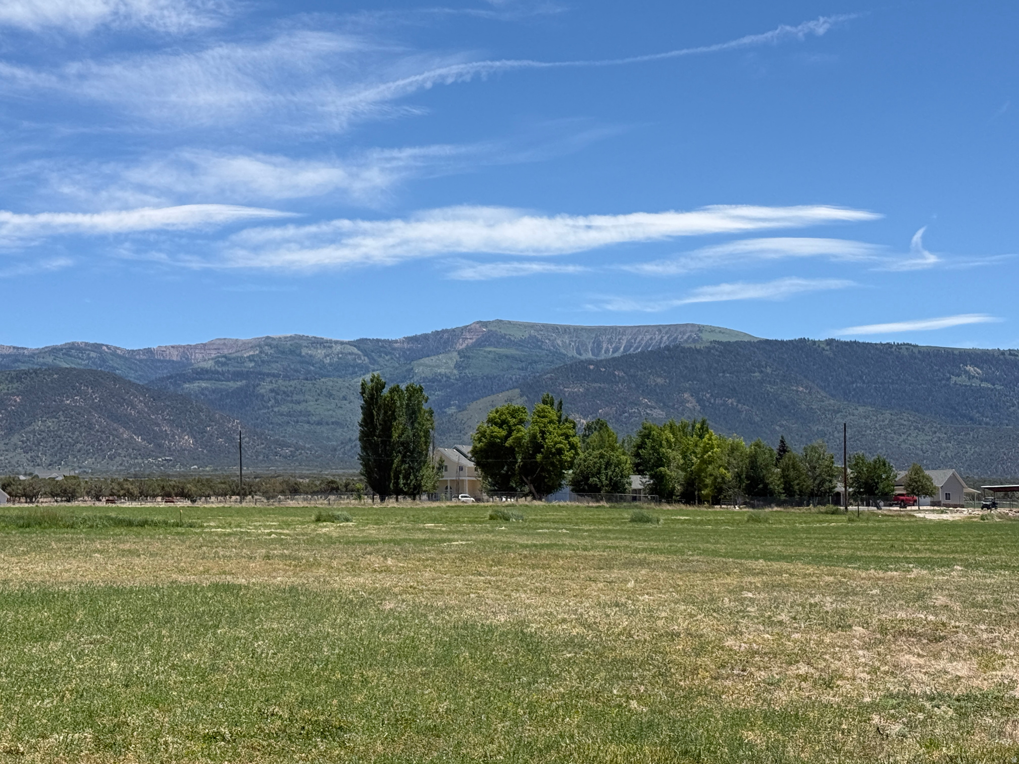 30.22 acres of lush land just outside the historic community of Spring City, bordering a natural pond to the west. This property has some excellent upside development potential, situated in the RA-2 zone which allows 1 LOT PER ACRE, with 60 irrigation shares included. Shares can be converted for a well. The beauty and tranquility of the area is special, with Horseshoe mountain to the southeast!  Power lines are located along the graveled county plowed and maintained road, on the south side frontage. The irrigation is pressurized and covers most of the acreage. Crops include alfalfa and small grains for rotation crops. Typical yield is 4.5 to 5 tons per acre. More acreage available. Coordinates are 39.4621707, -111.5072011  Elevation is 5,840 ft. Buyer to verify all information.