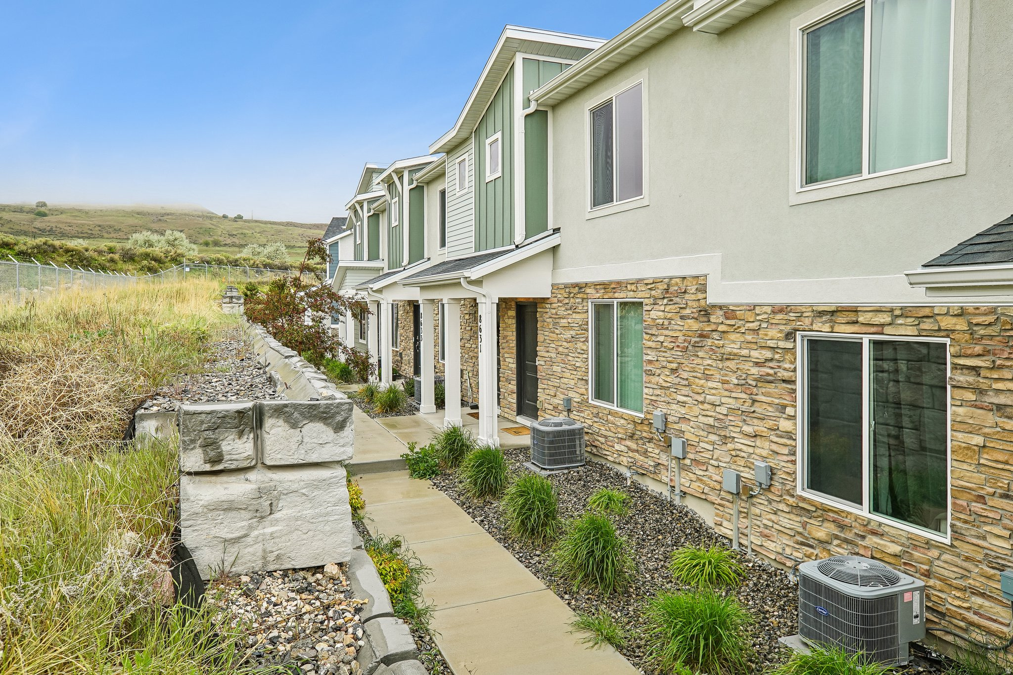 Discover modern luxury in this pristine 2024-built townhouse located in the sought-after Little Valley Gateway community. Designed with a sophisticated eye for detail, this residence offers an elevated living experience meets total convenience, featuring high-end stainless steel appliances. The open-concept interior unites the kitchen, dining, and living spaces in a bright, sun-drenched atmosphere. The primary suite serves as a private sanctuary, complete with its own dedicated bathroom and a generous walk-in closet. The property's position within the community is uniquely advantageous, offering a rare sense of openness with no immediate neighbors directly in front of the home, while the rear is conveniently situated steps away from guest parking. For those looking toward investment potential, the community's allowance of short-term rentals presents a distinctive opportunity in today's market. Residents enjoy access to a refined suite of amenities, including a designer clubhouse and outdoor pool, all while maintaining a lifestyle that embraces both nature and urban accessibility. Located just a block away from Cyprus High School and offering effortless access to Highway 201, the Oquirrh Mountains, and downtown Salt Lake City, this home stands as a sophisticated gateway to the very best of the Salt Lake Valley.