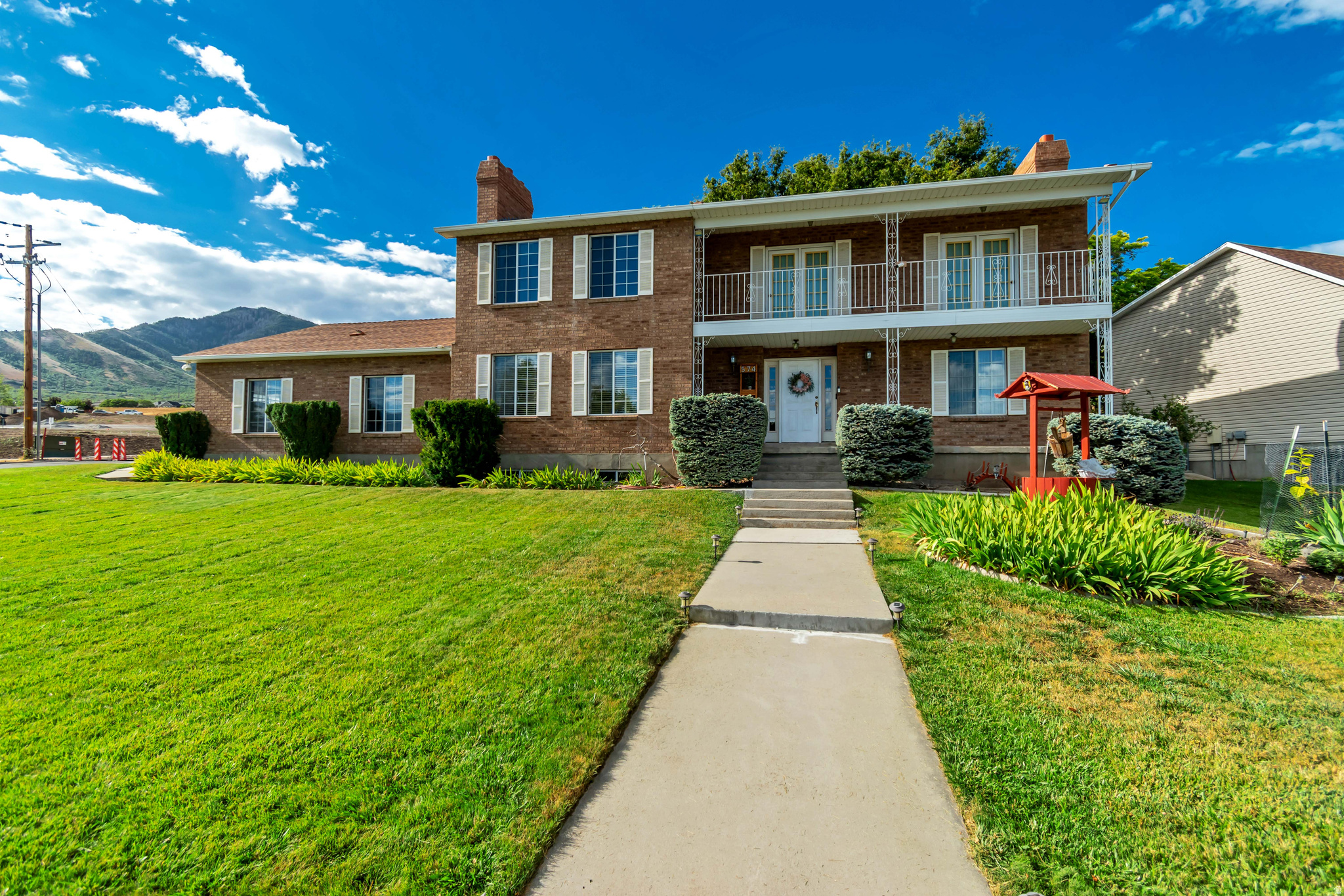 Exceptionally clean brick 2-story home in Tooele featuring 6 large bedrooms and 4 bathrooms. Enjoy stunning valley views from the second floor balcony. The formal dining room includes a large granite dining table. Spacious kitchen offers a large window and granite bar table overlooking the backyard. Marble flooring in the entry. Main floor laundry and four fireplaces. A convenient smart thermostat provides efficient climate control throughout the home. The oversized two-car garage includes a very large built-in storage area and basement entry-ideal for rental income. All appliances included. The beautiful yard features an oversized storage shed and ample space to easily add RV parking in a desirable Southeast Tooele location. Square footage figures are provided as a courtesy estimate only and were obtained from the previous MLS listing.  Buyer is advised to obtain an independent measurement.
