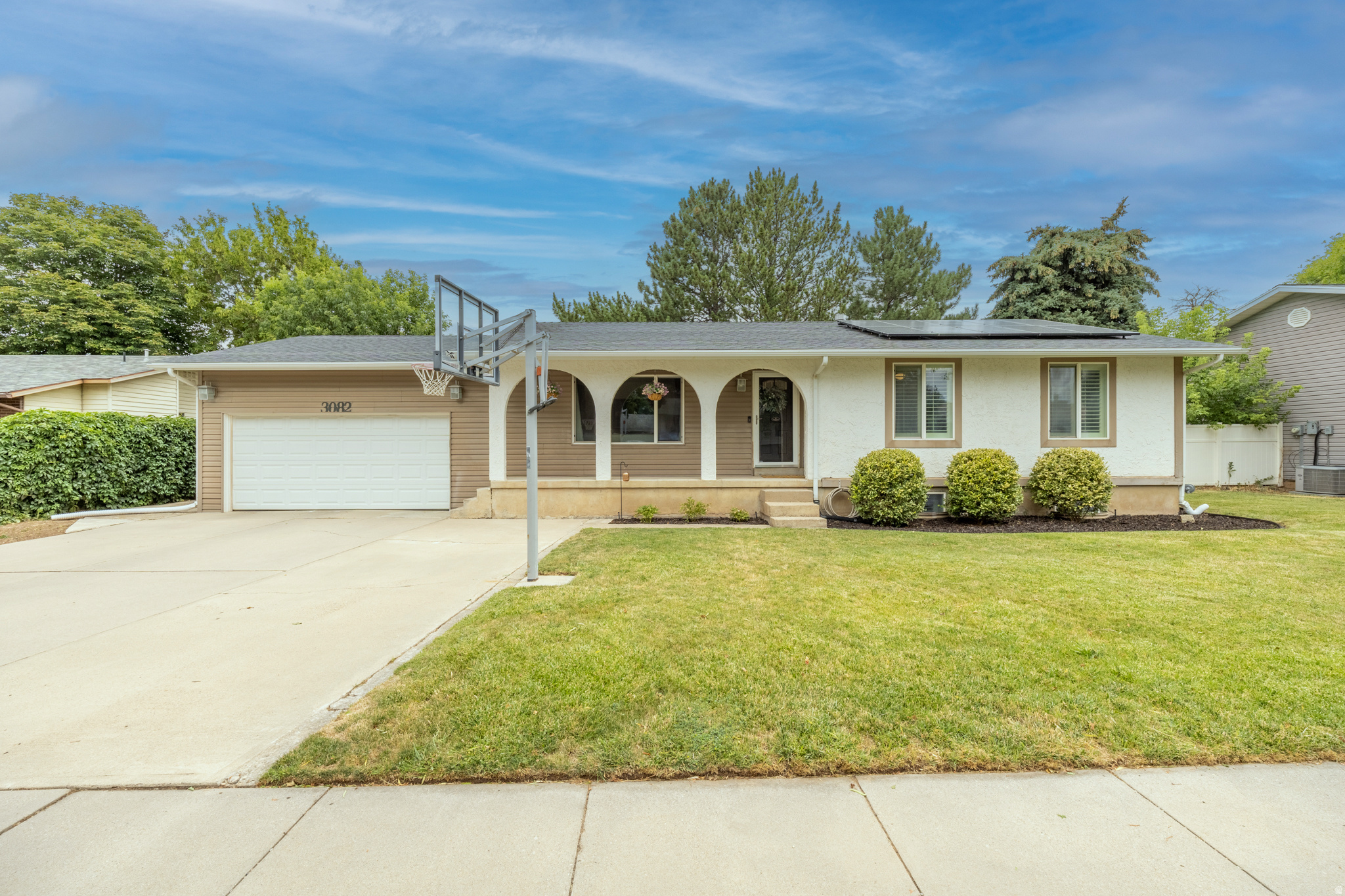 OPEN HOUSE JULY 30, 4-7pm. Enjoy golf course living in this beautifully updated rambler sitting on the 5th hole of Eagle Lake Golf Course! The kitchen, dining room, primary bedroom, and spacious back deck all overlook the green, offering a front-row seat to golfers' approach shots just beyond a row of Austrian pines and the backyard fence. A private gate provides direct access to the course, making it easy to step out for a round or simply enjoy the peaceful setting. Inside, you'll find 4 bedrooms, 3 bathrooms, and a dedicated office space in the basement, providing plenty of room for family, guests, or working from home. The basement also features a home theater complete with a projector & receiver that are included with the home, creating the perfect space for movie nights or watching the big game. The updated kitchen is equipped with modern appliances, all of which are included with the home, and the washer and dryer are included as well, making this home truly move-in ready. The fully fenced backyard is designed for relaxing and entertaining with both a patio and a deck overlooking the course along with an included hot tub, while the inviting front porch adds even more outdoor living space. The pull-through garage offers added convenience for vehicles, trailers, or extra storage.  Owned solar panels help keep utility costs exceptionally low, with summer power bills averaging around $35 per month. Conveniently located just two blocks from newly widened 5600 South and only five minutes from Hill Air Force Base, shopping, restaurants, and everyday amenities, this home combines an exceptional location, energy efficiency, and one-of-a-kind golf course views. **SCROLL UP for tours. First tour is virtual, second tour is a video tour.