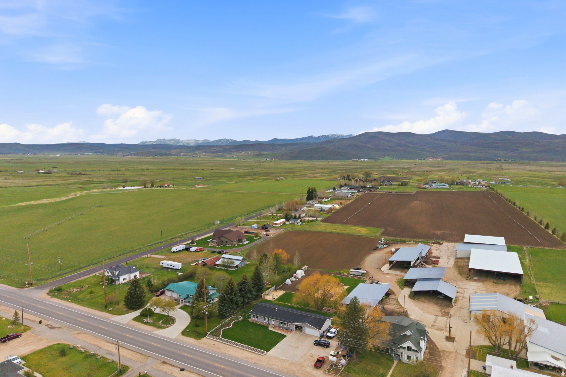Some homes hold history in their walls. This Victorian farmhouse in Marion, Utah is one of them. Originally built in 1895 and thoughtfully rebuilt on its original footprint in 2019, the home honors its heritage with soaring Victorian ceilings, generously proportioned rooms, and original historic elements - while offering the complete comfort and confidence of modern construction throughout. The heart of the home is a large, beautifully appointed kitchen designed for gathering - equally at home for a quiet morning or a table full of people. A main level primary suite with ensuite provides single-level convenience, while upstairs two bedrooms and a flexible lounge space - already plumbed for a kitchenette or wet bar - offer privacy and versatility for guests, family, or creative use. Step outside and you are surrounded by the working agricultural landscape of the Kamas Valley - open fields and mountain views on three sides that no future development will ever disturb. It is the kind of setting that feels increasingly rare and increasingly valuable. Two minutes down the road, High Star Ranch is becoming one of Utah's most compelling year-round destinations - with 16 miles of world class trails, equestrian facilities, exceptional events, and the soon-to-be-opened Beaumont Bakery at the Country Store. A 150-room hotel and expanded resort amenities are underway the future plans evolve, bringing new energy to a valley that has always deserved it. Park City is 18 miles away. Salt Lake International Airport is 45 minutes. The mountains, trails, and rivers of the Uinta and Wasatch are right outside your door. This is Summit County living at its most authentic - heritage, landscape, and location, before the rest of the world catches up.  3D Matterport Tour: https://my.matterport.com/show/?m=KhFwatXXNru
