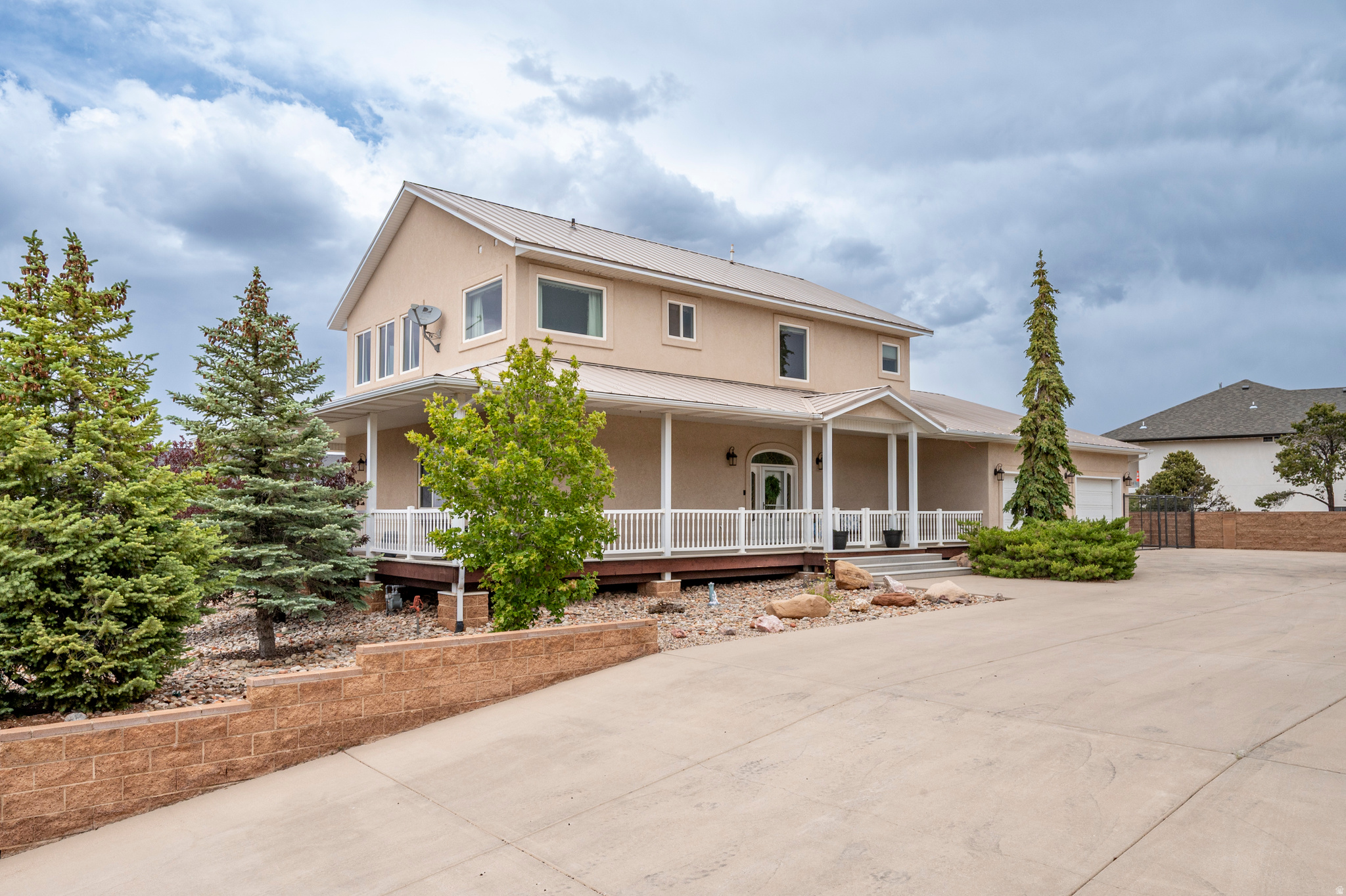 Stunning home overlooking the Cedar City Temple, beautifully xeriscaped for low-maintenance living and abundant parking for RVs and all your toys. This spacious 4-bedroom, 4-bath home also offers two additional flex spaces perfect for a home office, gym, hobby room, or playroom. Three of the four bedrooms feature private ensuite bathrooms, providing exceptional comfort and privacy for family and guests alike. Designed to impress, this home features a wraparound deck and countless upgrades, including a newer $13K Sub-Zero refrigerator, A/C unit, furnace, flooring, and dishwasher. The chef's kitchen is a dream with the Viking range/oven, oversized pantry, and large space for entertaining. The ''forever'' roof and deck provide peace of mind, making this home as practical as it is beautiful!