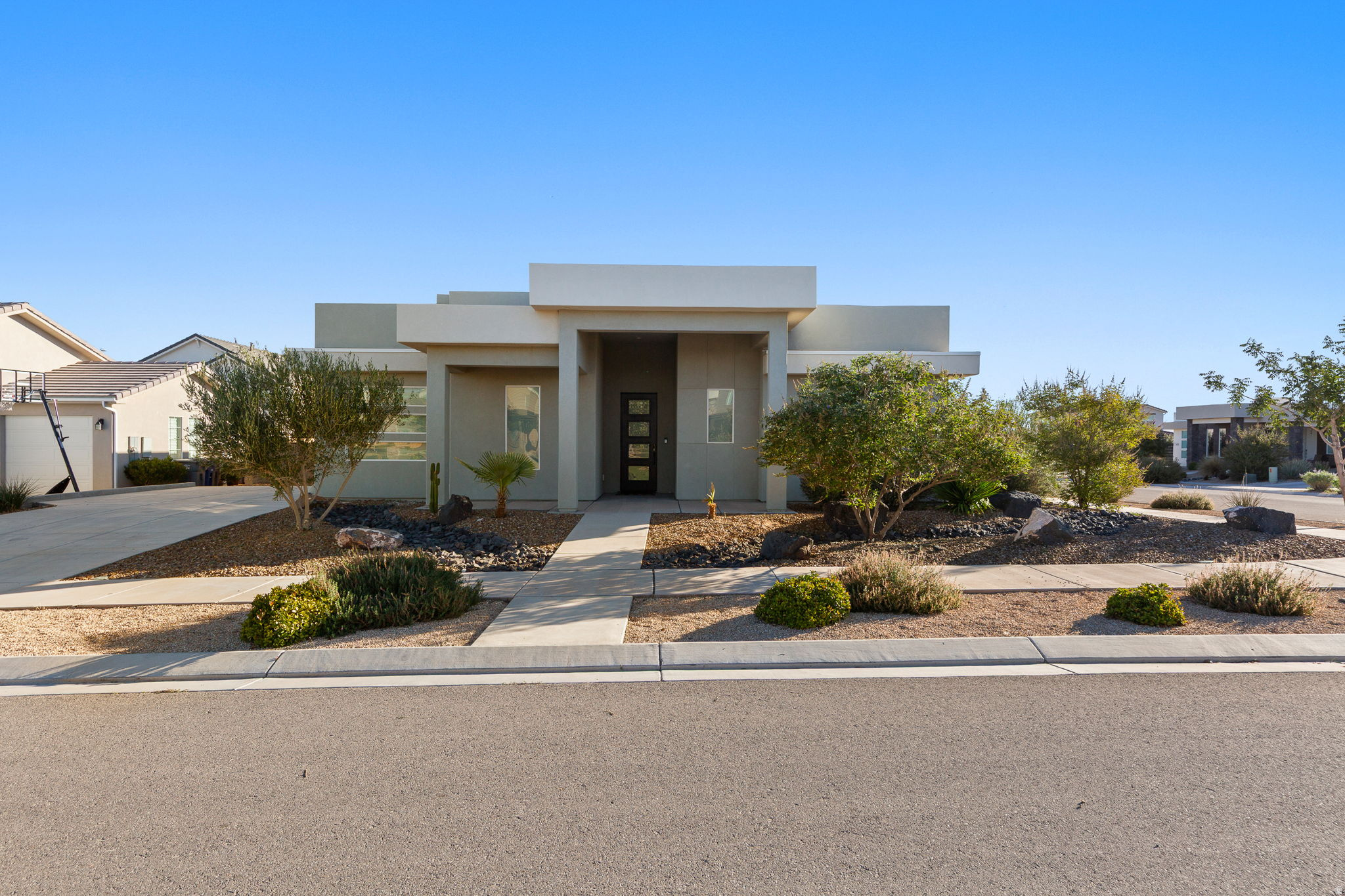 This well maintained part-time home sits in the heart of Desert Color, one of Southern Utah's most active and convenient communities. As a second home, it's been gently lived in and feels better than new, with upgrades that make a real difference day to day. The home has a clean, modern elevation and a fully desert-scaped yard for minimal upkeep-perfect if you want the look without the work. Inside, you'll notice the high ceilings and tall doors that make the home feel open and bright. The refrigerator/freezer, washer, dryer, and water softener are all included. Custom roller window shades and a tray ceiling in the main living area add a polished touch. The primary suite is private and comfortable, and the additional bedrooms are great for guests, each with its own walk-in closet. Outside, there's room to add an RV garage if you need more storage or flexibility down the road. Desert Color has an unbeatable vibe; community events, restaurants, trails, and of course, the 2.5 acre lagoon. There's plenty more on the way too, including Costco, a movie theater, a car wash, and more. It's the kind of place where you can stay busy or simply relax and enjoy the lifestyle.