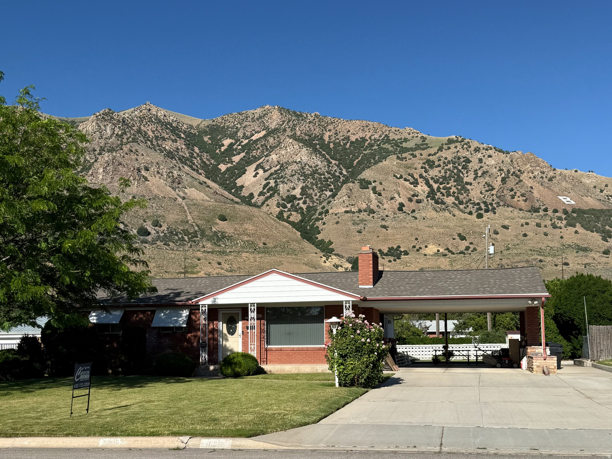 CHARMING ONE-OWNER HOME WITH MOUNTAIN VIEWS ON .32 ACRE LOT.  Pride of ownership shines throughout this well-maintained, one-owner home, lovingly cared for since it was built. A spacious family room addition off the kitchen expands the main level to approximately 1,466 square feet, creating an inviting space for gathering and everyday living.  The heart of the home is the oversized kitchen, featuring a large island, double ovens, abundant counter space, and plenty of storage-perfect for cooking, entertaining, and family meals. The main floor offers three bedrooms, a full bathroom, and a convenient  bath connected to the primary bedroom.  Enjoy cozy evenings by the fireplace, with fireplaces located on both the main level and in the basement. Downstairs, you'll find an additional family room and bedroom, offering plenty of space for guests, hobbies, or future updates. Approximately half of the basement remains unfinished, providing excellent storage and room to customize to your needs.  Recent improvements include a new HVAC system and a new water heater, giving buyers peace of mind. Outside, the generous .32-acre lot features a full sprinkler system, irrigation shares, and stunning mountain views that create a beautiful backdrop year-round.  This is a rare opportunity to own a solid, meticulously cared-for home with great living space, valuable updates, and endless potential to make it your own.  Square footage figures are provided as a courtesy estimate only and were obtained from County records.  Buyer is advised to obtain an independent measurement.