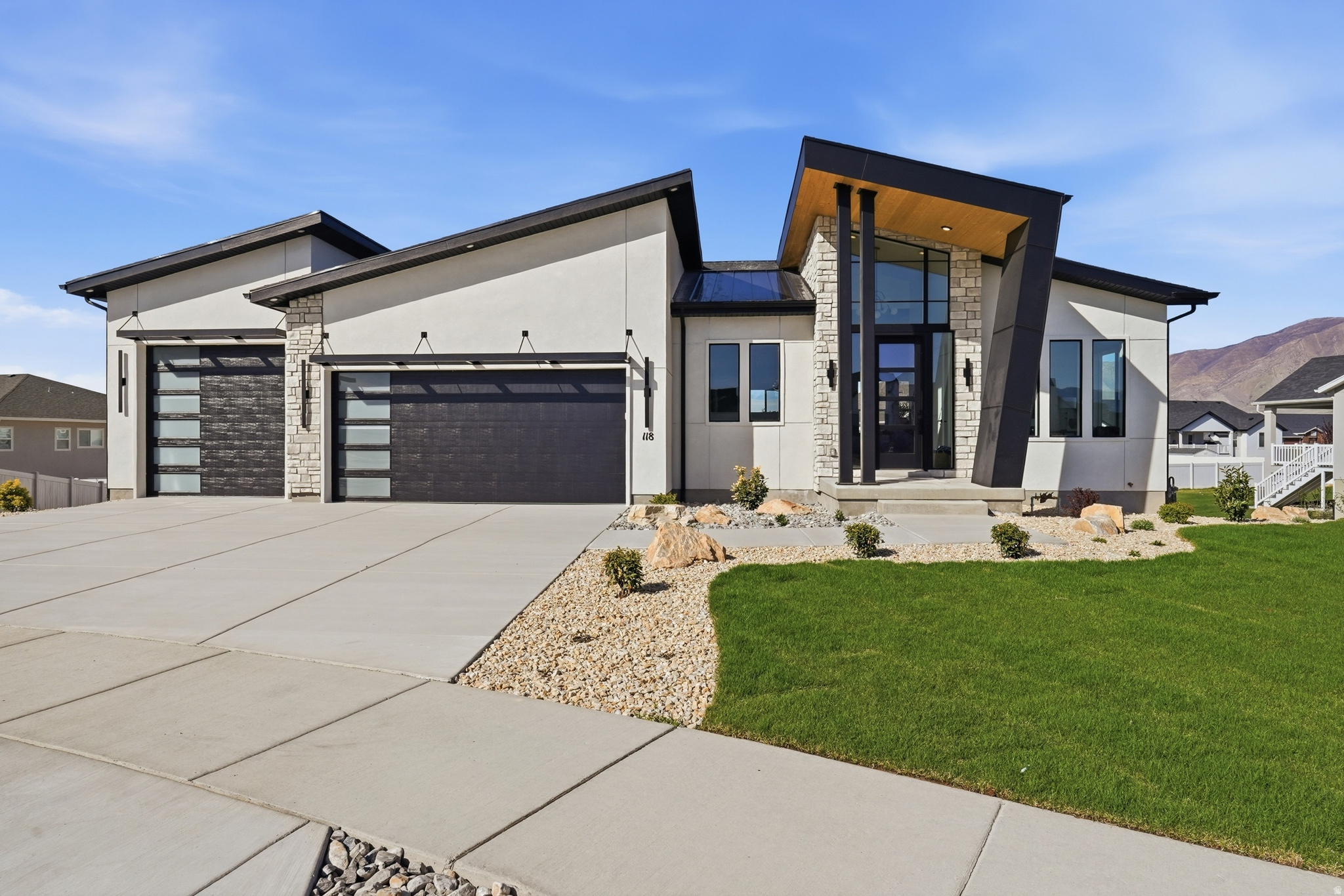 Welcome to this exceptional home nestled on a quiet cul-de-sac in Stansbury Park, where modern design meets expansive views and everyday functionality. Set on a generous lot, this property stands out with impressive curb appeal, a spacious layout, and a stunning mountain backdrop.  The heart of the home is a large, open-concept kitchen featuring a generous serving bar-perfect for gathering, entertaining, and hosting family and friends with ease. The seamless flow into the main living area creates an inviting space designed for both everyday living and special occasions.  Enjoy the convenience of a main-level primary suite, offering a true retreat with a spa-like bathroom and a spacious walk-in closet. Downstairs, a large family room provides additional living space and opens to a walkout patio, leading to a sizable backyard ready for your personal touch-ideal for creating your own outdoor oasis.  With its combination of location, lot size, and modern appeal, this home offers a rare opportunity to enjoy peaceful suburban living while remaining close to local amenities, schools, and outdoor recreation.