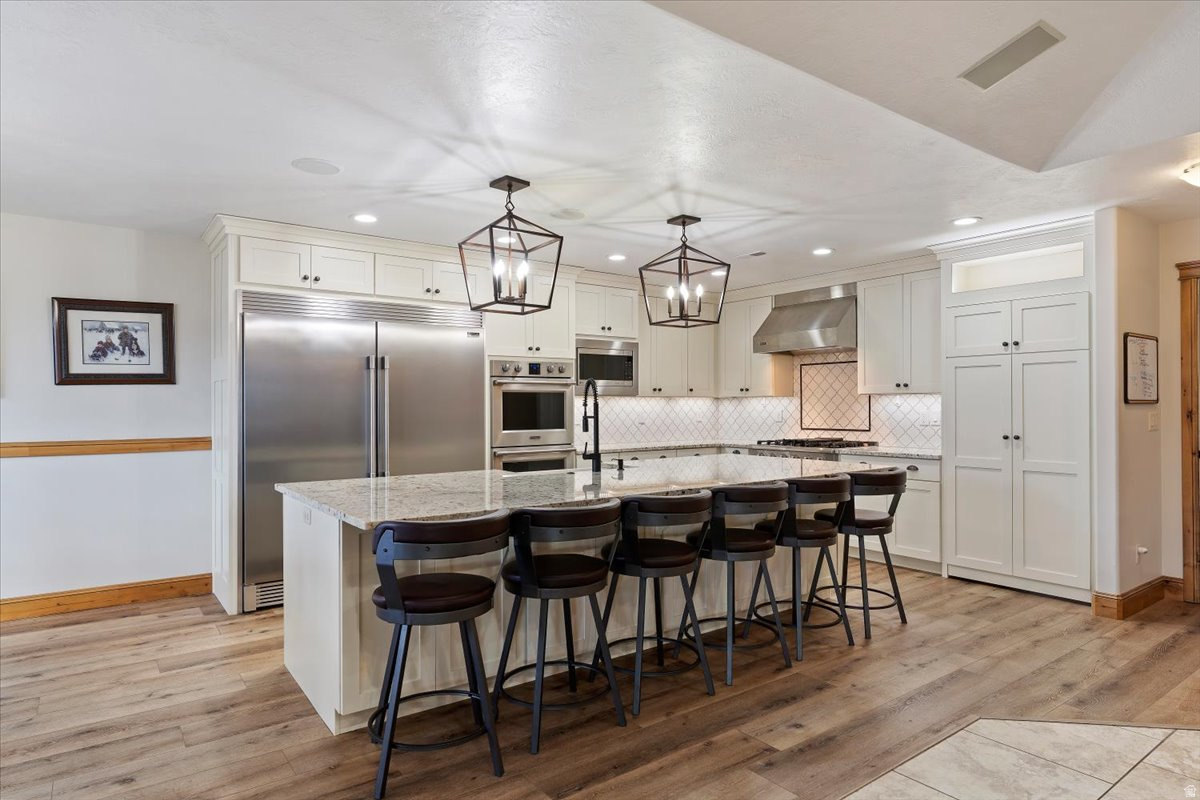 Located in Liberty, Utah, this property puts you at the doorstep of Pineview Reservoir and some of the most sought-after ski resorts in the state, all while sitting on a private, HOA-free lot with mountain views that are genuinely hard to beat. This is the kind of location that draws people to Utah in the first place - and this home delivers.  Inside, the fully remodeled chef's kitchen is built for real use - a built-in refrigerator, double ovens, a 5-burner gas range, and a walk-in pantry with a dedicated Costco door that makes stocking up effortless. The open floor plan keeps the kitchen connected to the main living areas, making it easy to host. The primary suite is a standout, with double sinks, a steam shower with dual showerheads, and a jetted tub - the kind of setup you'd expect in a high-end resort, not a primary home.  A large flex room with 270 wraparound mountain views offers endless possibilities - home office, gym, studio, or simply the best seat in the house.  The basement is its own destination. Radiant heated floors run throughout, a wet bar anchors a fantastic hangout space built for game nights and gatherings, and a dedicated theatre room gives everyone a place to unwind.   Then there's the garage. A 5-car heated garage with RV parking up to 54 feet long, a built-in EV charger, and a solar system to offset the energy costs - this setup is as practical as it is impressive. Whether you're storing snowmobiles, boats, ski gear, a full-size RV, or plugging in an electric vehicle, everything has a place. And with no HOA, there are no restrictions on how you use any of it.  Liberty is a tight-knit community with quick access to everything the area offers - powder days at Powder Mountain, Snowbasin, and Nordic Valley, summer days on Pineview, and trails year-round.