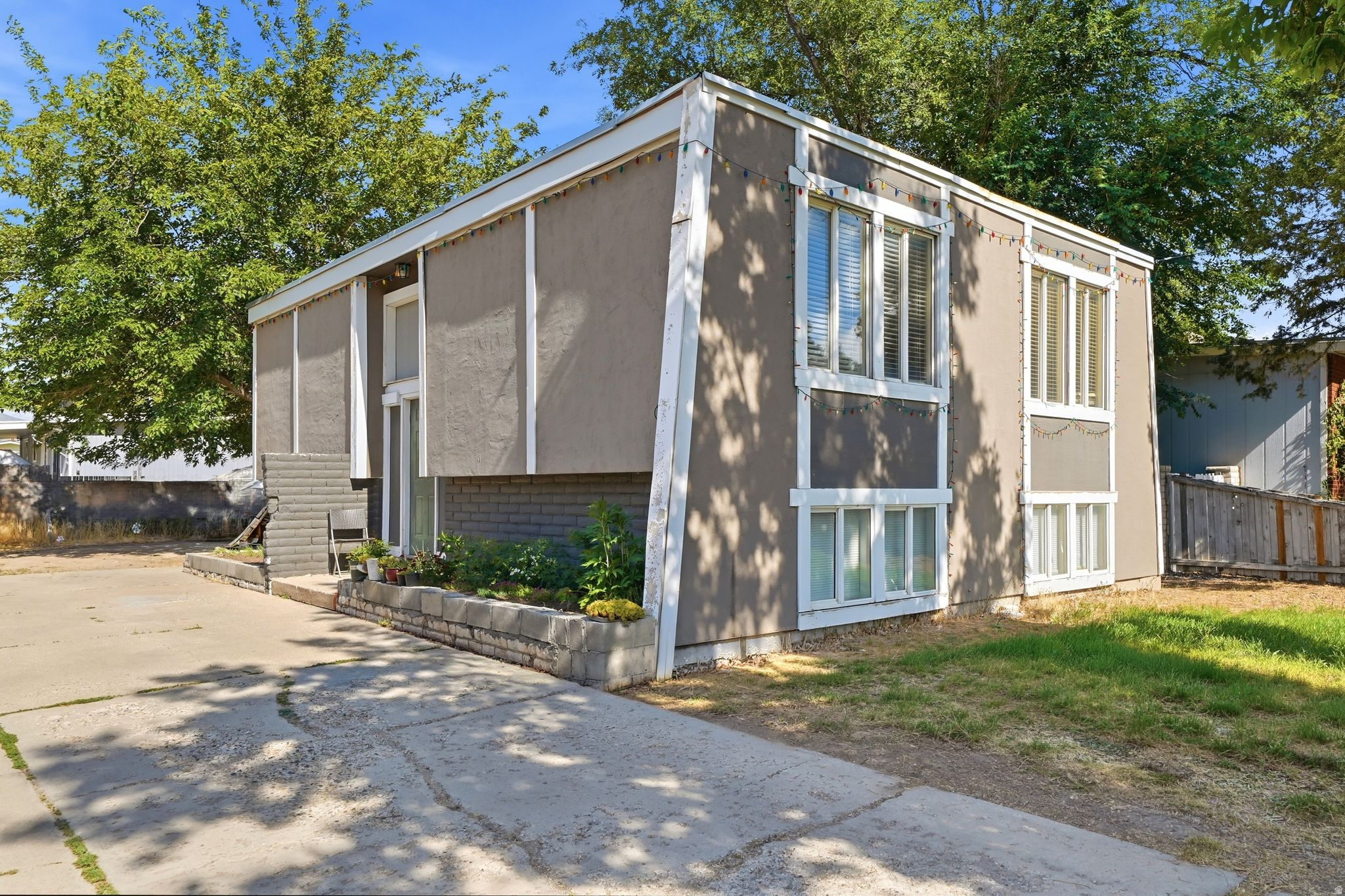 This beautifully maintained home features an open-concept floor plan filled with abundant natural light and breathtaking views of the Wasatch Mountains. Fully renovated in 2019, the home offers numerous updates, including new interior paint, A/C, furnace, water heater, and a brand-new bathroom vanity installed just last week. A separate basement entrance provides excellent flexibility for multigenerational living, a mother-in-law apartment, or future rental income potential. The refrigerator, washer, and dryer are all included, making this home truly move-in ready. Conveniently located near shopping, restaurants, schools, and everyday amenities, the home is adjacent to John F. Kennedy Jr. High School and a UTA bus stop for easy commuting. This is an incredible opportunity to own a move-in-ready home in a prime central location!