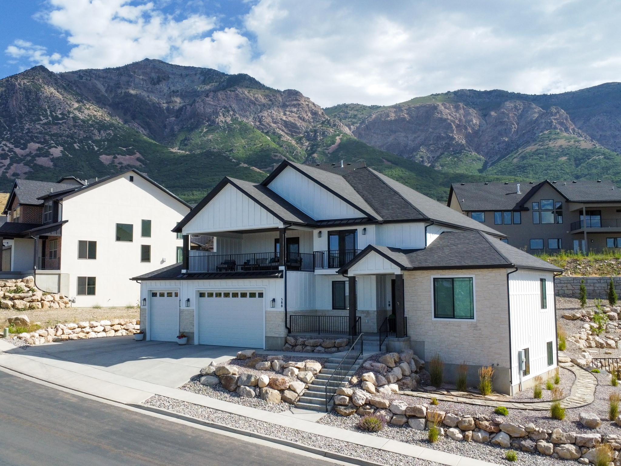 Perched to capture stunning mountain views from the backyard and sweeping valley views from the front, this beautifully upgraded home offers luxury, space, and exceptional craftsmanship throughout. The open-concept design features soaring 20-foot ceilings, engineered wood flooring on all three levels, two gas fireplaces, and a chef's kitchen with quartz countertops, an oversized island, a large walk-in pantry, and reverse osmosis water filtration. Enjoy the expansive covered deck, a luxurious primary suite with a Jetta soaking tub and walk-in shower, and a fully finished basement that adds valuable living space. Additional features include separate upper-level HVAC, a tankless water heater, a 40-foot RV pad, and a radon mitigation system with a transferable warranty.