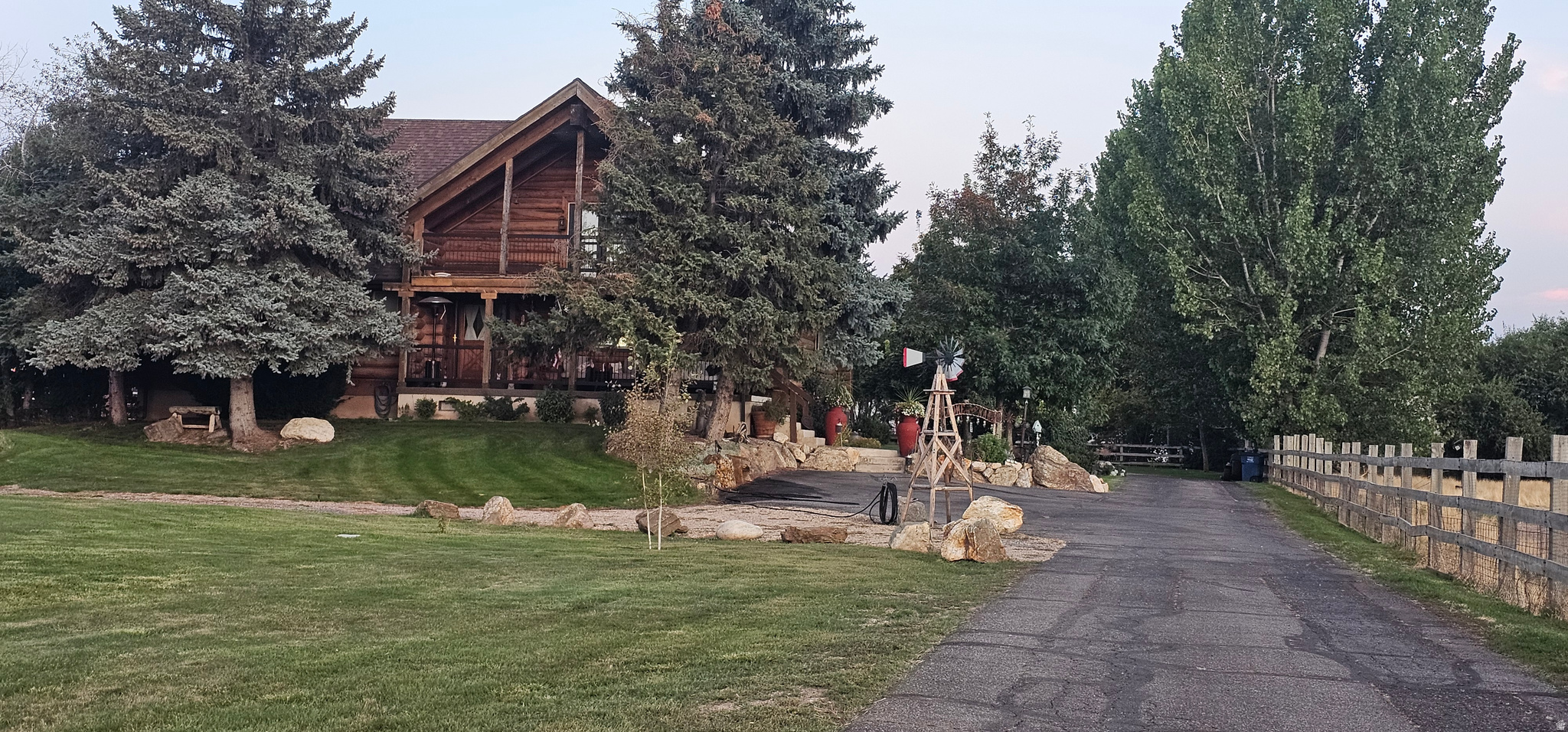 MOTIVATED SELLERS ARE RELOCATING.  Want to feel like you're in the country while remaining close to the city, then this home is for you and your family. This log home is nestled down a 300' driveway. It has 6-bedroomes, 4 bathrooms, 2-laundry rooms. The home sits on 1.47 fully fenced acres of land. Property has been approved for a split 2 parcel lots. Perfect for entertaining large groups or families. Outside you will find plenty of parking, a 2700 sqft covered pole barn, fire pit, horseshoe pits, and a fully enclosed for safety, 20X40 heated in ground swimming pool with new liner in 2024 w/separate changing room attached to a newly built (2024) workshop. Large open grass areas for almost any type of games. This home is a "Must tour". It has a massive kitchen with double ovens and a large granite center island next to a lovely dining room. Wood accents throughout, massive living rooms and one having an open beam ceiling. There is also a private office that has been recently remodeled in 2025. This home comes with a master suite you could play football in, which also comes with its own private balcony as you exit the French style doors accompanied by storm doors on the outside. Water softener and water purifier. The basement is fully finished with full a kitchen, laundry room, 2 bdrms, cold storage, and has a full walkout with separate drive and parking if desired. RV parking with 220 plugs. Separate storage building does come with the home (purchased new in 2021). 2 HVAC units, 2-water heaters. Almost too much to list so please make appointments to come visit. Buyer to verify all county records in regard to the buildable lot a back of property. We also ask that there are no random drive-by viewings (private gated driveway), and please serious buyers only. Owners have pets that need to be removed prior to showings.