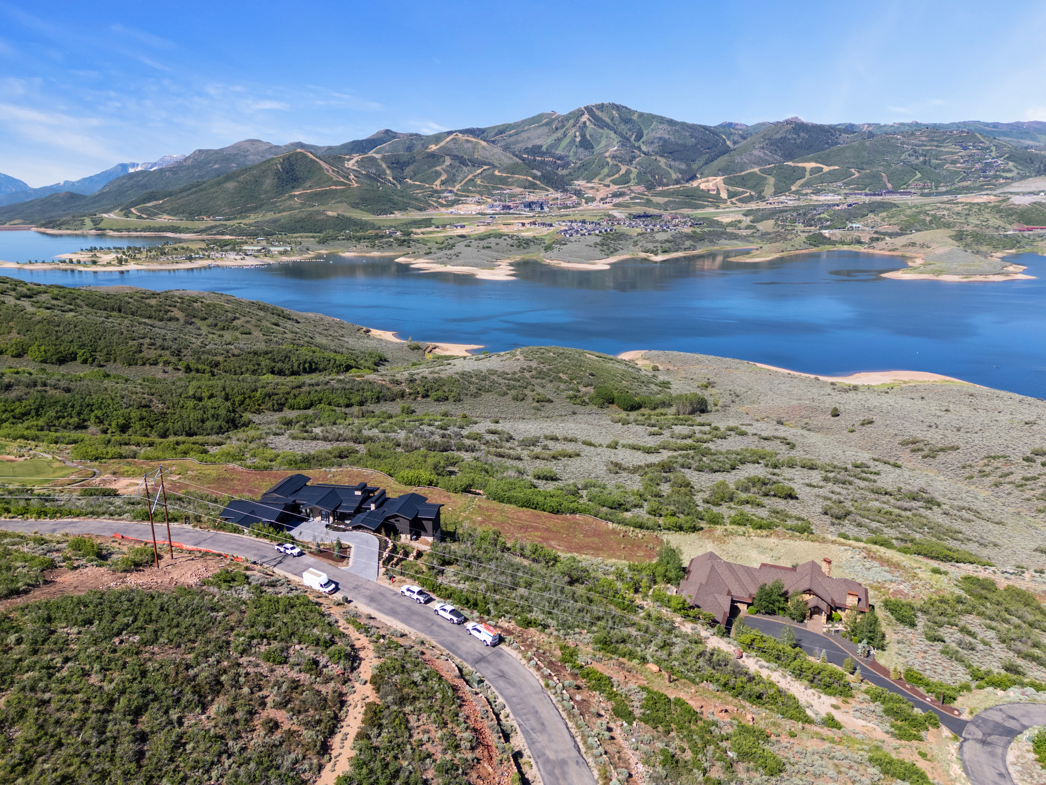 Build your dream home of up to 10,000 square feet on one of the premier view lots in the Park City area. Situated on a downhill slope along a private gated road, this exceptional homesite offers unobstructed views of Deer Valley, Lake Jordanelle, and the surrounding mountains.  Perched above neighboring properties, the lot enjoys a unique sense of privacy and openness, with panoramic views stretching for miles. With no homes between the property and the lake, you'll enjoy breathtaking scenery, colorful sunsets, star-filled skies, and cool evening shade throughout the summer months.  This homesite is ideally positioned to take full advantage of the surrounding natural beauty while remaining close to world-class recreation. Residents enjoy access to a private golf course, parks, trails, and abundant outdoor activities year-round. Deer Valley's East Village gondola is just minutes away, while boating, paddleboarding, and fishing on Lake Jordanelle are easily accessible during the summer season.  Conveniently located approximately 45 minutes from Salt Lake City International Airport and 15 minutes from Historic Main Street Park City, this property offers the opportunity to create a custom mountain retreat in one of Utah's most sought-after locations.