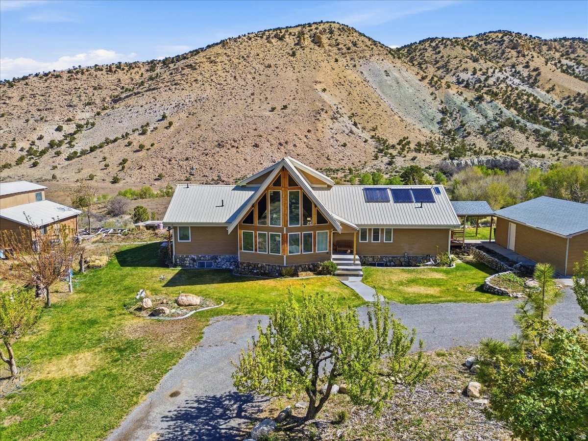 Stunning custom-built home nestled on 92.46 acres of pristine Utah landscape, offering sweeping mountain and valley views in every direction. Located in the quiet community of Mayfield, this exceptional property is perfectly suited for horse enthusiasts, hobby farmers, or anyone seeking space, privacy, and the freedom to create their own rural retreat. With all this acreage, there is ample opportunity to expand operations-ideal for grazing, farming, or adding greenhouses and additional outbuildings. The home itself was thoughtfully designed and carefully constructed with both comfort and functionality in mind. Inside, you'll find spacious living areas, oversized rooms, and quality finishes throughout. A beautiful spiral staircase serves as a centerpiece on the main level, complemented by rich wood cabinetry that adds warmth and character. The upper-level loft provides flexible space for an office, additional sleeping area, or recreation room. The basement includes a large family room and convenient walk-out entrance, offering great potential for entertaining, multi-generational living, or guest accommodations. Step outside to the expansive deck where you can take in breathtaking sunrises, peaceful mornings, and star-filled night skies-perfect for relaxing or hosting gatherings. Features are already in place, including a well-equipped horse barn with stalls, a 2-car garage, and multiple storage sheds complete with workbenches to keep tools and equipment organized and protected year-round. The lower portion of the property offers even more charm and usability, featuring a private picnic area, swings for gatherings, a peaceful pond, and wide-open space ready for recreation, livestock, or future improvements. Ideally located just minutes from Nine Mile Canyon and Palisade State Park, you'll enjoy convenient access to outdoor recreation including fishing, golfing, ATV/UTV riding, and horseback trails. Experience the best of country living with modern comforts, endless possibilities, and year-round adventure right outside your door.  Square footage figures are provided as a courtesy estimate only and were obtained from Sanpete County .  Buyer is advised to obtain an independent measurement.