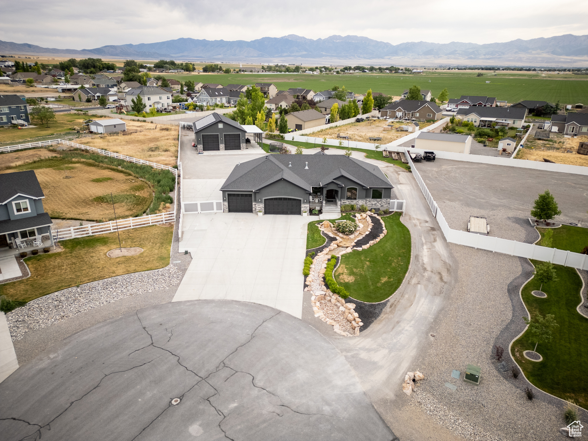 Situated in the quiet, private "Field of Dreams" subdivision.  Must see to appreciate this upscale upgraded Gem. vaulted ceiling and recessed lighting,Spa-like bathroom: 126 sq ft walk-in tile shower, heated floors, double marble sinks, bidet, and 73 sq ft walk-in closet with custom built-ins  Guest Bedrooms: 144 sq ft each with carpet flooring and closet organizers,Guest Bathroom: Custom cabinetry, pull-out drawers, tall toilet, tile walls, and marble countertop,Flooring: Plank tile throughout main areas, carpet in bedrooms,chisled edge Marble countertops, full-height subway tile backsplash, Double oven, gas cooktop inset, matching custom vent hood, Farmhouse porcelain sink and dishwasher in island,Recessed can lighting; open concept to dining and living,Rock gas fireplace with shiplap and dimmable lighting,Large covered deck accessible from master bedroom and dining area with scenic views,Custom wood front entry door, Carpeted stairs with custom metal railing to basement,Finished Walk-Out Basement: Convertible Bar Area (ideal for second kitchen setup), Theater Room: 336 sq ft, fully wired with high end Denon, and Klipsch sound system including 15" sub-woofer system, includes leather reclining theater seating (2 rows), with raised second row. Craft/Guest Room: 372 sq ft, custom shelving, carpet floors Under-Stair Kids' Play Area: TV wired, includes sensory boards, Full Bathroom: Spa tub, Cold Storage Room: 232 sq ft, Security &amp; System Upgrades, 2 Vault-style Security Doors leading to secure rooms, CCTV System with transfer panel + security cameras, Central Vacuum System Upgraded Fixtures &amp; Windows throughout, Decorated Window Wells Over 5000ft of low voltage wiring, full house Klipsch sound system in every room,including porches, all controllable from phone app. Full whole house Cat-6 Copper network with custom "network center",Garage &amp; Shop Facilities,Attached Garage,5-Car Drive-Through Garage, Custom Metal Workbench + Wall &amp; Hanging Shelving, Water Hose Hookup (hot and cold soft water line for car washing), Gas Heater Installed,Detached Shop (40x60 ft) Extra-Height Electric Garage Doors, Huge Covered RV Carport with Dump Station, Gas Heater Installed,  Bathroom,2 Large Custom Metal Workbenches, Wall Shelving Units, Fully finished 60 ft Loft with HVAC &amp; Heating, custom cabinets, Ample Storage Cabinets Fiber connection to house network with media converters, Wi-Fi setup,Exterior &amp; Landscaping,Fully fenced white vinyl yard fencing,Custom landscaping with: Large waterfall feature in front yard, two waterfalls, Fruit trees and garden beds,Energy &amp; Backup Power, Two Tesla Solar Systems that include: 6 Tesla Power Walls, Solar Panels, 12 kW Hours of generation,Generac 26 Kw Standby Generator,All systems wired to automatically support both house and shop power if a power outage is detected.,Sound Proofing, Main floor has spray foam, All walls have RockWool Safe 'n' Sound Soundproofing and Fire-Resistant Stone Wool Insulation Batt