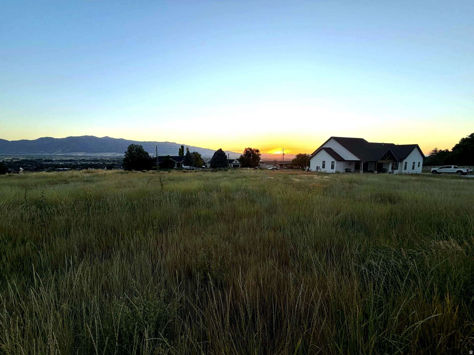 Flat, gorgeous view lot in Providence .44-acre lot in Providence, ready to build. Most nearby hillside lots need retaining walls and grading work before you can build; this one doesn't. It's flat, has gorgeous mountain views, and all utilities (electric, natural gas, culinary water, sewer) are already at the property line. Street is paved and publicly maintained. Rectangular lot, so you've got flexibility on where to place a home. No HOA. Quiet residential area a few minutes from Logan, close to shopping and schools. One of the few flat, view-ready lots left in the area.