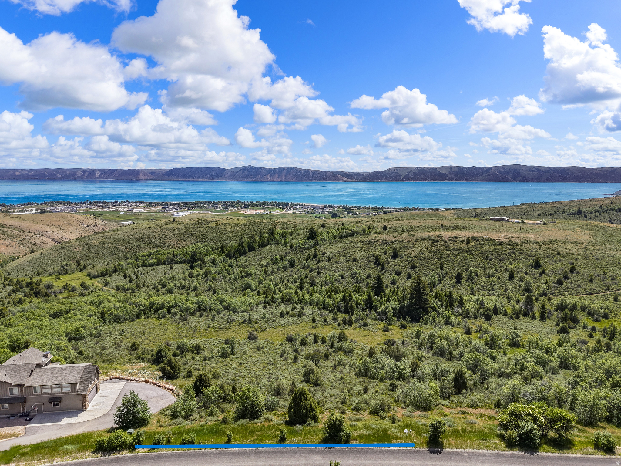 Build ready 0.99-acre Bear Lake lot in Eagle Feather at Shundahai offering paved year-round access, electricity and sewer available, and an ideal setting for a custom Bear Lake retreat, vacation home, or future income-producing build. Seller has engineered home plans that may be included with the sale, giving buyers a valuable head start on the building process (also available as a to be built listing at MLS#2165066 ). The property is approx 6 minutes to the lake and marina, and only 15 minutes from Beaver Mountain Ski Lodge. Miles of nearby mountain trails, you can drive, ride or hike straight from your doorstep. Buyer to verify all HOA, zoning, utility, permitting, and short-term rental licensing requirements. (shundahaihoa.org).