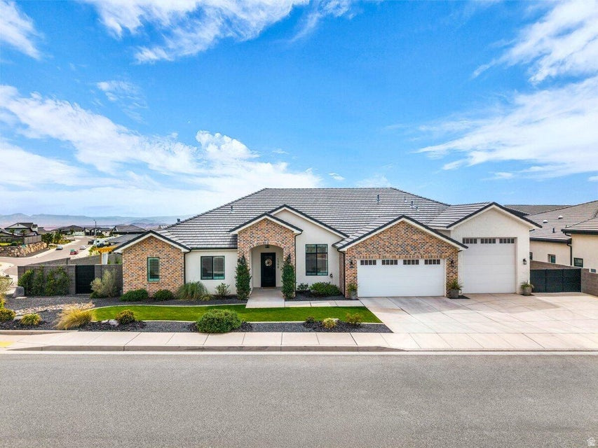Experience elevated Southern Utah living in this custom owner-built home with NO HOA, thoughtfully designed with high-end upgrades throughout. Take in breathtaking panoramic views of the city and surrounding mountains from a property that truly captures the beauty of the area. The backyard is an entertainer's dream featuring a massive, covered patio, outdoor TV, firepit, fireplace, and a fully equipped outdoor kitchen with a built-in pizza oven! Inside, the home shines with a huge kitchen island, commercial-sized fridge and freezer, pot filler, induction cooktop, premium quartz, and a spacious butler's pantry with leathered granite and a barn sink. A stackable, accordion sliding glass wall creates seamless indoor-outdoor living, perfect for gatherings year-round. The oversized primary suite offers two private entrances from outside, a spa-ready setup, and a massive walk-in closet complete with laundry hookups. Additional highlights include designer-grade carpet, floor-to-ceiling tile, stacked stone accent walls, and a large laundry room. The impressive 44' RV garage features a 12x12 door, 16' interior width, and extra storage space to accommodate all your toys. With the community backing to BLM land, enjoy direct access to endless trails, perfect for biking, ATVs, and outdoor adventure right from your doorstep! Buyer to verify all information, deemed reliable, however, buyer to verify all info including utilities, rental restrictions, and ACC information if applicable.