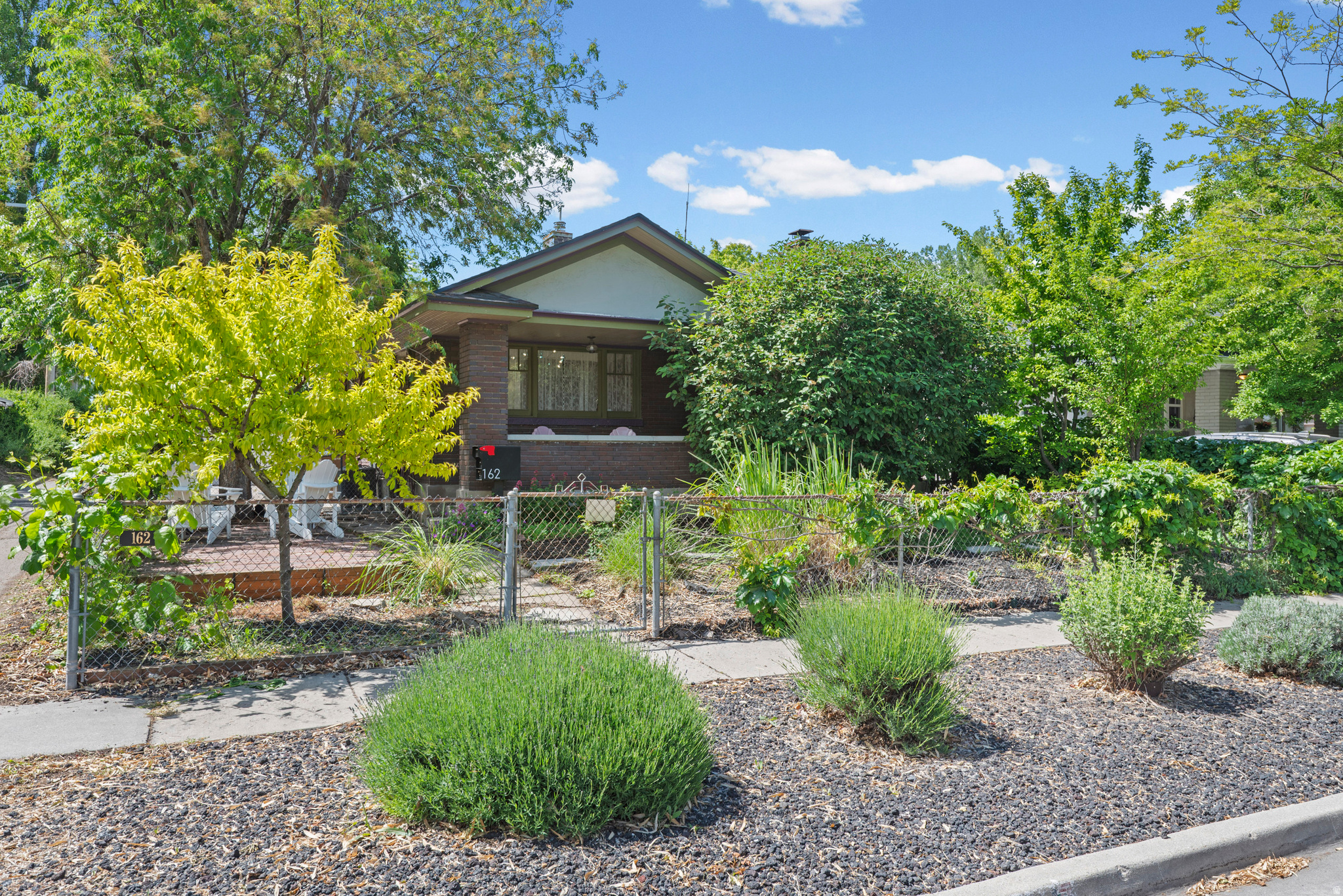 Historic charm, thoughtful updates, and one of the city's most versatile detached studio spaces come together in this beautifully maintained bungalow in the heart of Salt Lake City. Set on a quiet, tree-lined street just minutes from Liberty Park, 9th & 9th, Central 9th, Ballpark, and some of the city's most beloved restaurants, cafs, breweries, and shops, this home offers exceptional walkability and an effortless urban lifestyle without sacrificing warmth or privacy. Inside, original wood floors, vintage built-ins with glass doors, and a professionally converted natural gas fireplace preserve the home's historic character while adding everyday comfort and ease. The open living and dining spaces feel both inviting and functional, with a generous foyer rarely found in homes of this era. The kitchen blends old and new with a six-burner Viking range, butcher block and granite countertops, original glass-front cabinetry, and a striking island topped with green-veined marble and crafted from an authentic Scandinavian farm table. The spacious primary bedroom opens directly onto a covered back deck through stained glass French doors, creating an easy indoor-outdoor flow. Downstairs, two additional bedrooms are accompanied by a generous laundry and storage area, with eco-friendly wool carpeting bringing warmth and softness to the lower level. Multiple outdoor living areas, including a covered back deck, courtyard firepit area, new hot tub, mature peach and plum trees, and a natural gas grill connection, create a private, retreat-like atmosphere ideal for entertaining or quiet evenings at home. Stay with me, because there's more! A standout feature of the property is the detached studio with cedar ceilings and skylights, offering incredible flexibility as an art or music studio, home office, fitness space, workshop, or creative retreat. The garage has also been thoughtfully arranged to function as either storage/workspace or vehicle parking. Major system updates include all new plumbing within the last five years, tankless water heater, updated HVAC, and newer roof. Full radon mitigation system has already been installed, along with a whole house water filtration system. For qualified buyers, the home also offers the rare opportunity to assume an existing VA loan with an interest rate below 3%. Check out the virtural tour, and then schedule a showing today!