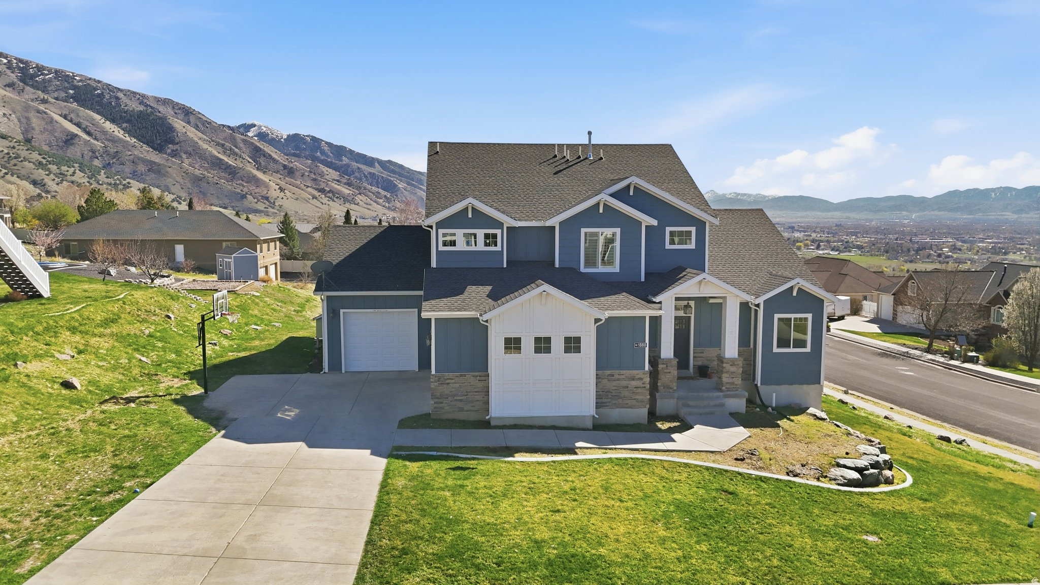 Wake up to sweeping mountain views and enjoy the peace and privacy of North Logan's highly sought-after east bench. Nestled on a rare 0.77-acre lot, this custom home offers the perfect balance of luxury, comfort, and outdoor living. Featuring a spacious main-floor primary suite, generous gathering spaces, a 3-car garage, and expansive windows that frame the surrounding scenery, every detail is designed to help you enjoy the beauty of Cache Valley. With trail access nearby, room to roam, and a location that's just minutes from town, this is more than a home...it's the lifestyle you've been looking for.
