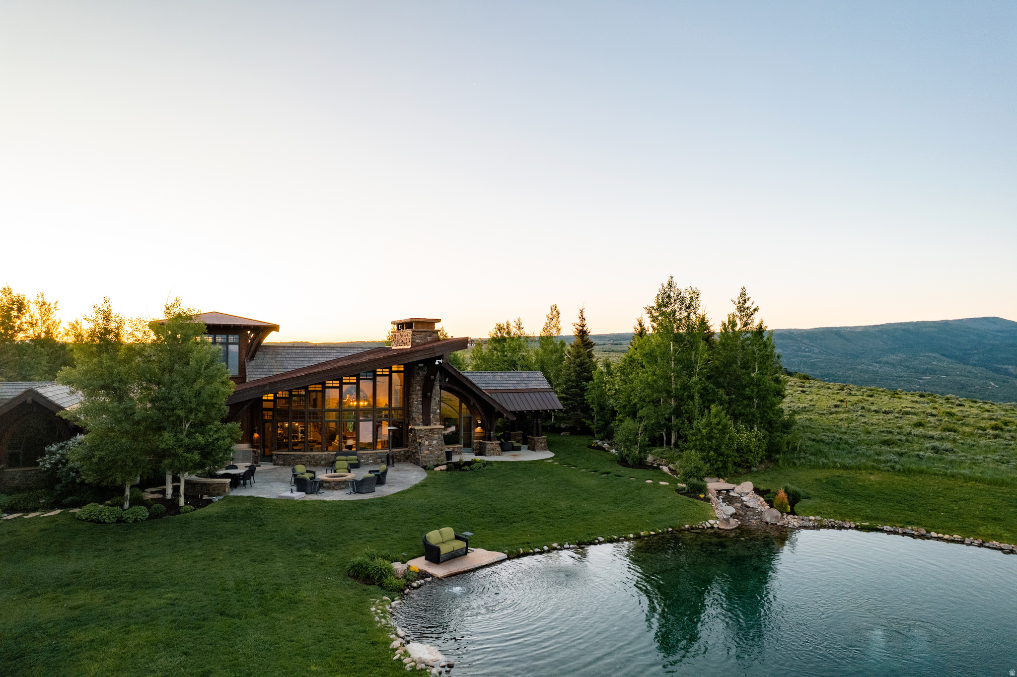 A rare opportunity to own one of the most private legacy ranch estates within easy reach of Park City, this extraordinary 160-acre holding in Wolf Creek Ranch offers a lifestyle that is increasingly impossible to replicate.  Set amid rolling meadows, mature timber, and panoramic mountain vistas, the residence is thoughtfully positioned to capture breathtaking views while maintaining seclusion. The 6,100-square-foot mountain retreat combines timeless craftsmanship with refined comfort, featuring soaring timber-beamed ceilings, expansive walls of glass, and warm gathering spaces designed for both intimate family moments and large-scale entertaining.  Unlike many luxury mountain properties, this estate offers the freedom and scale of true land ownership. The property includes a beautifully crafted barn accommodating up to four horses, extensive room for recreational vehicles and equipment, and direct access to miles of private trails that wind through the ranch's spectacular landscape. Whether horseback riding through alpine meadows, casting a line in private trout waters, exploring by ATV, or simply enjoying the serenity of your own mountain sanctuary, every season presents a new adventure.  Wolf Creek Ranch is one of the West's most coveted private land communities, encompassing thousands of acres of protected wilderness while remaining just minutes from the dining, shopping, and world-renowned ski resorts of Park City. Owners enjoy access to private trout ponds, the Upper Provo River, an owners' lodge, equestrian facilities, and over 60 miles of maintained trails.  Properties of this caliber are seldom available. Offering unmatched privacy, significant acreage, equestrian amenities, and convenient access to Park City's luxury lifestyle, this is more than a mountain home; it's a legacy estate designed to be enjoyed for generations.